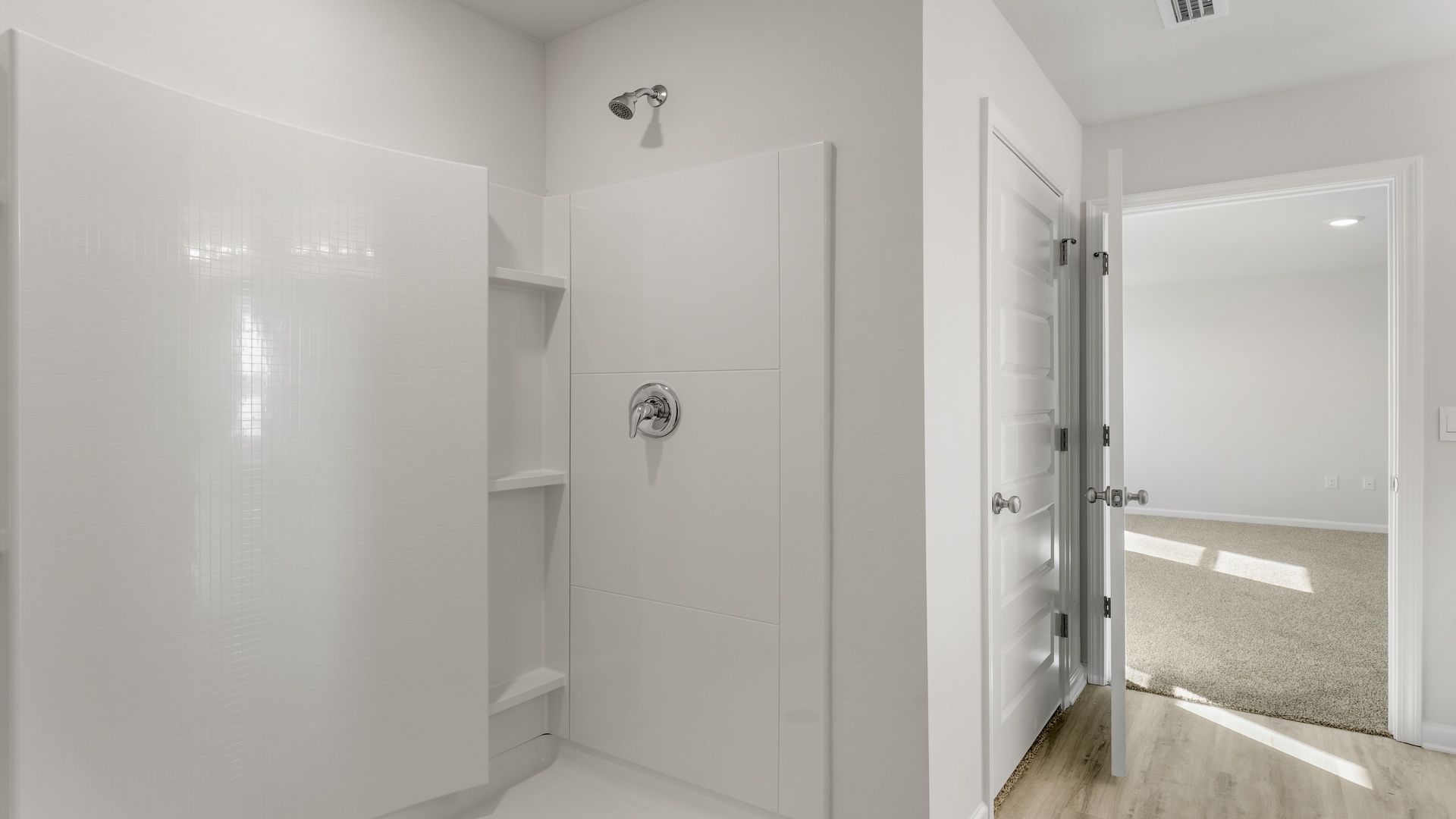 Primary bathroom with shower and bedroom entrance.