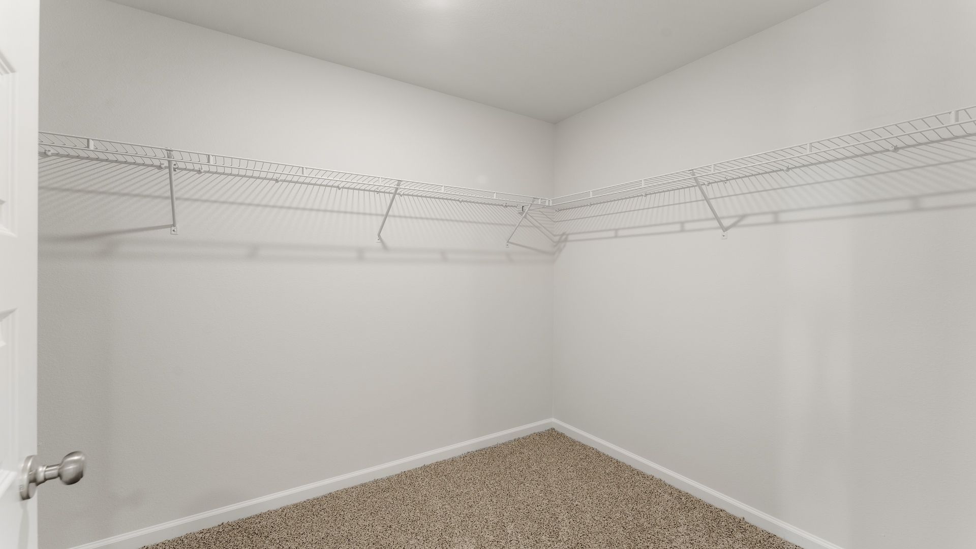 Bathroom walk-in closet with ventilated shelving.