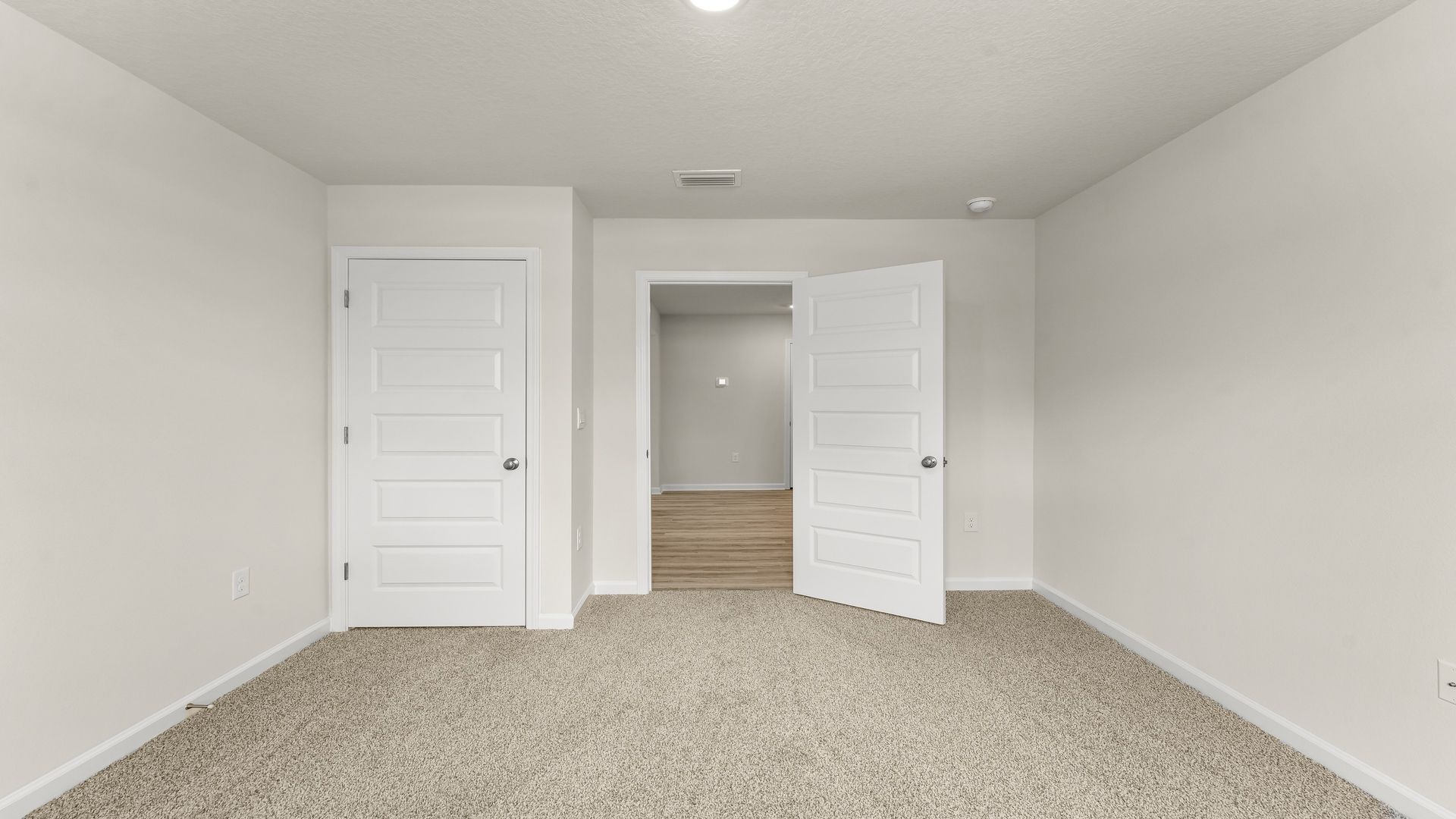 Bedroom with carpet floors and closet.