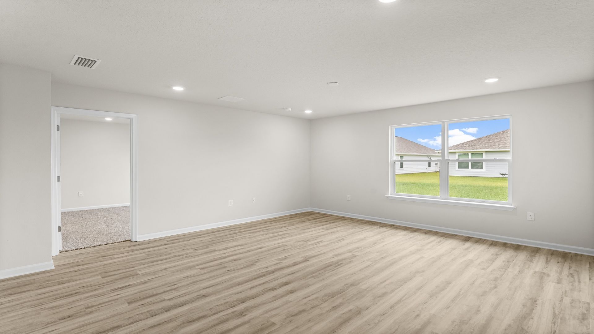 Living room with EVP flooring and window.
