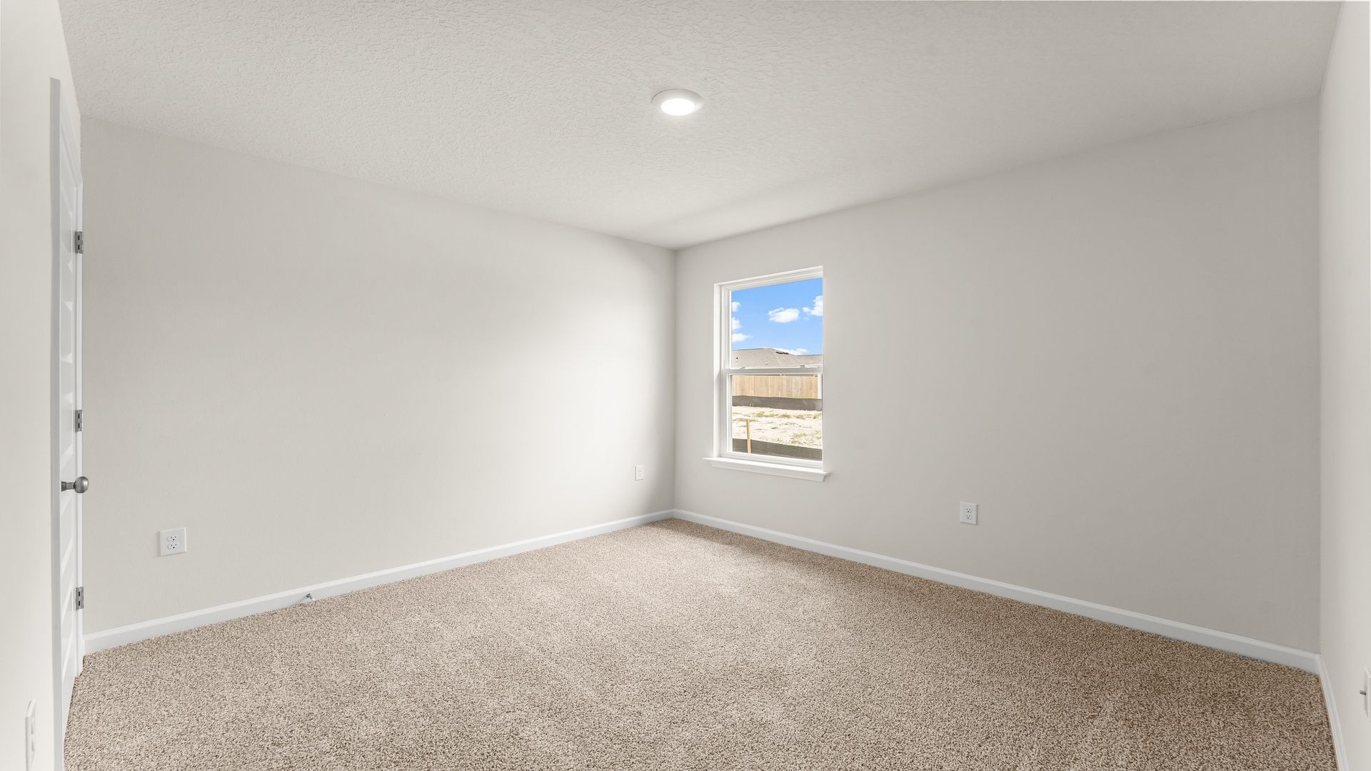 Bedroom with carpet floors and window.
