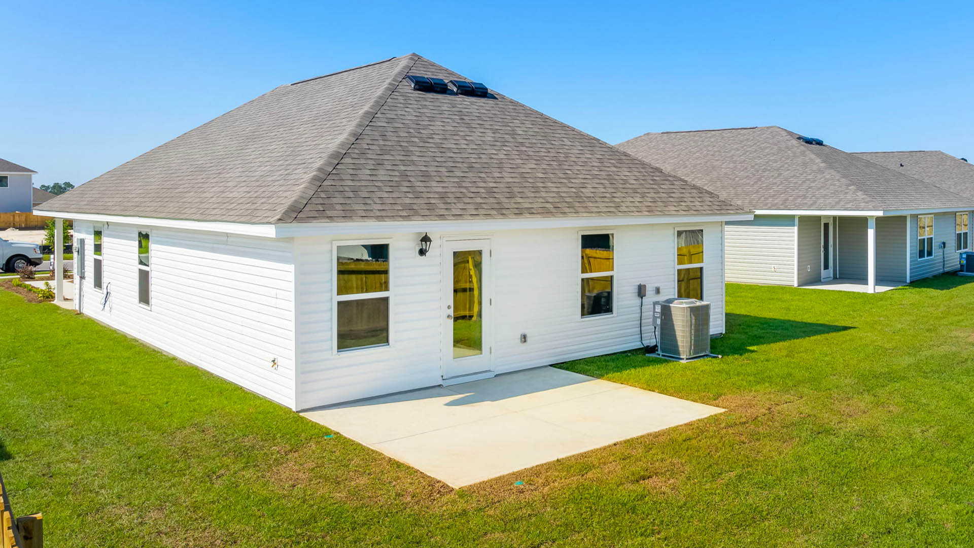 Celeste plan rear of home with concrete pad.