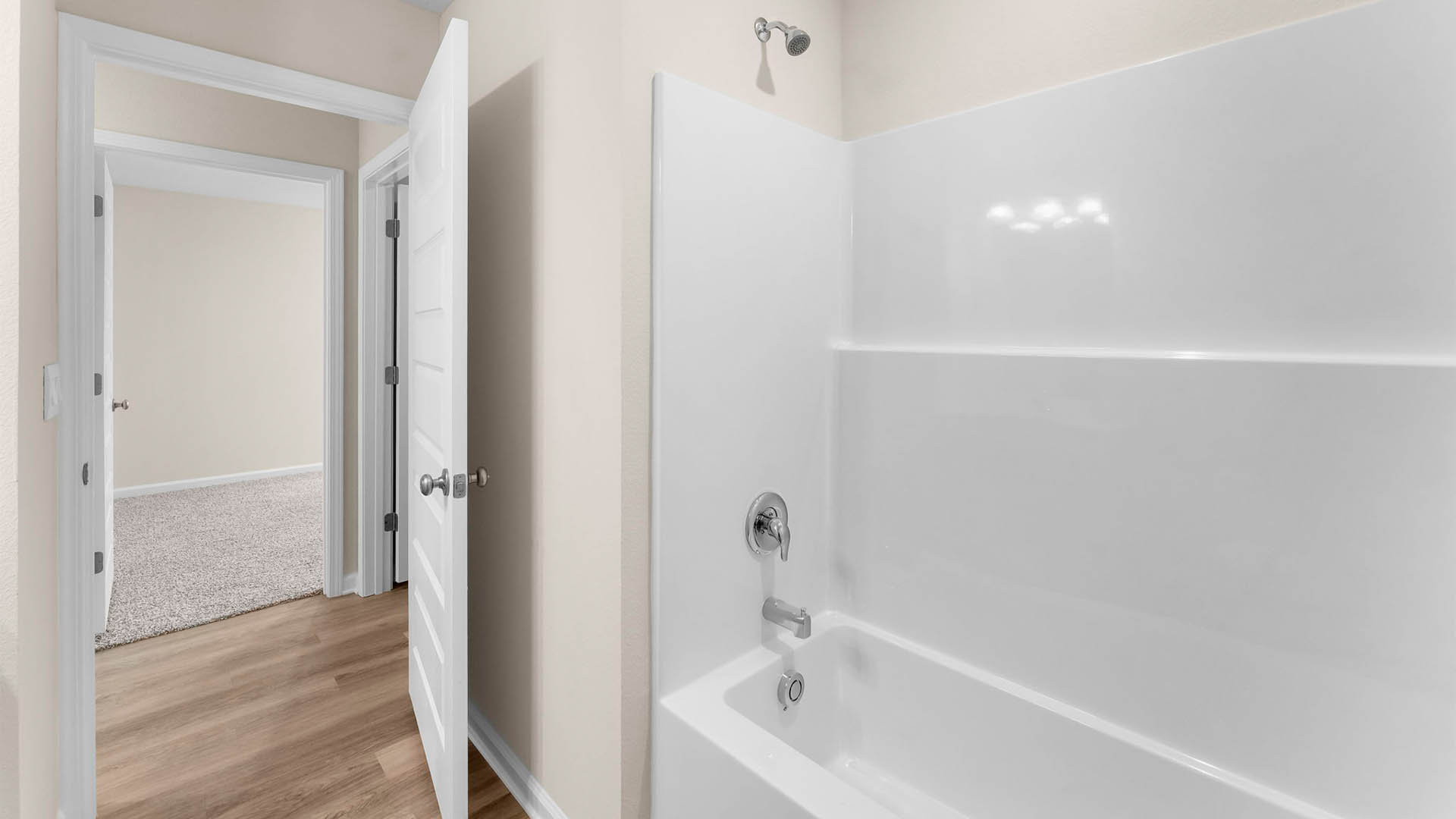 Bathroom with EVP flooring and shower tub combo.