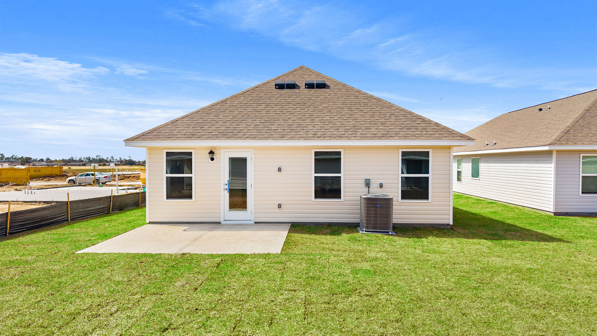 Celeste plan rear of home with concrete pad.