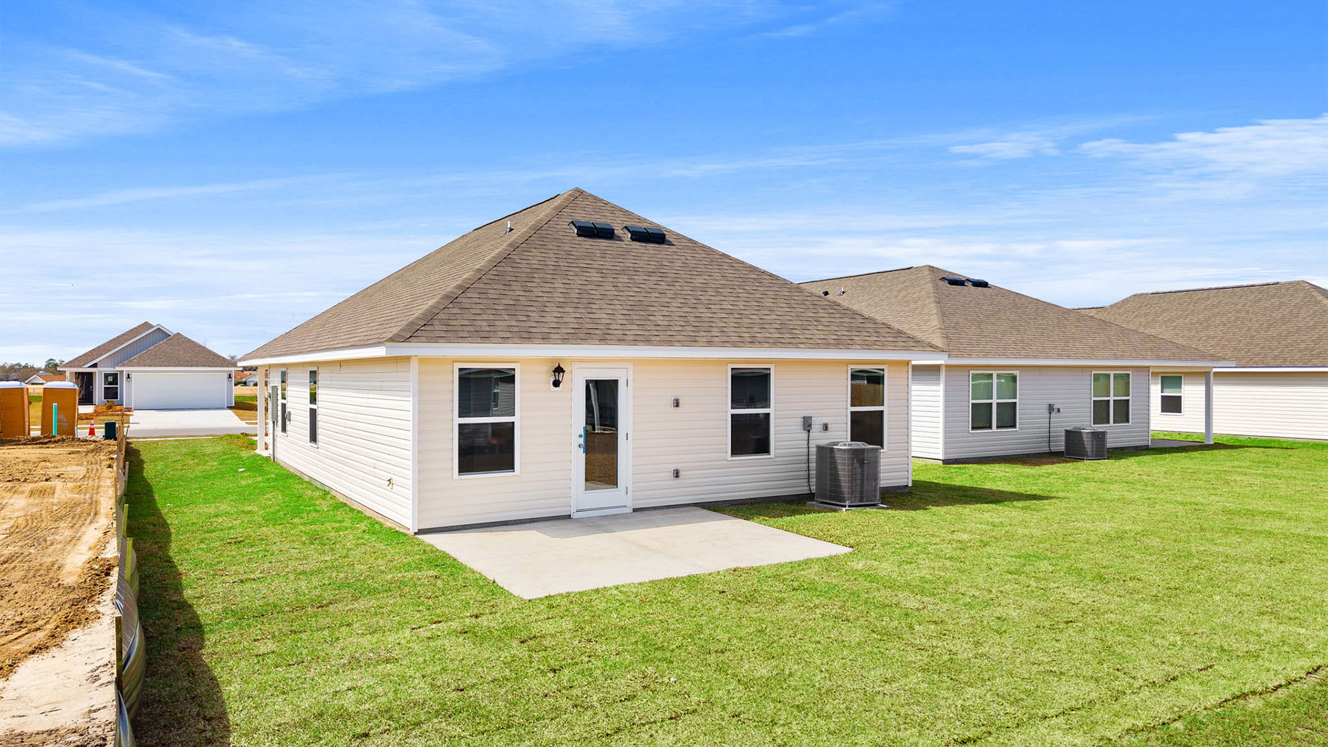 Celeste plan rear of home with concrete pad.