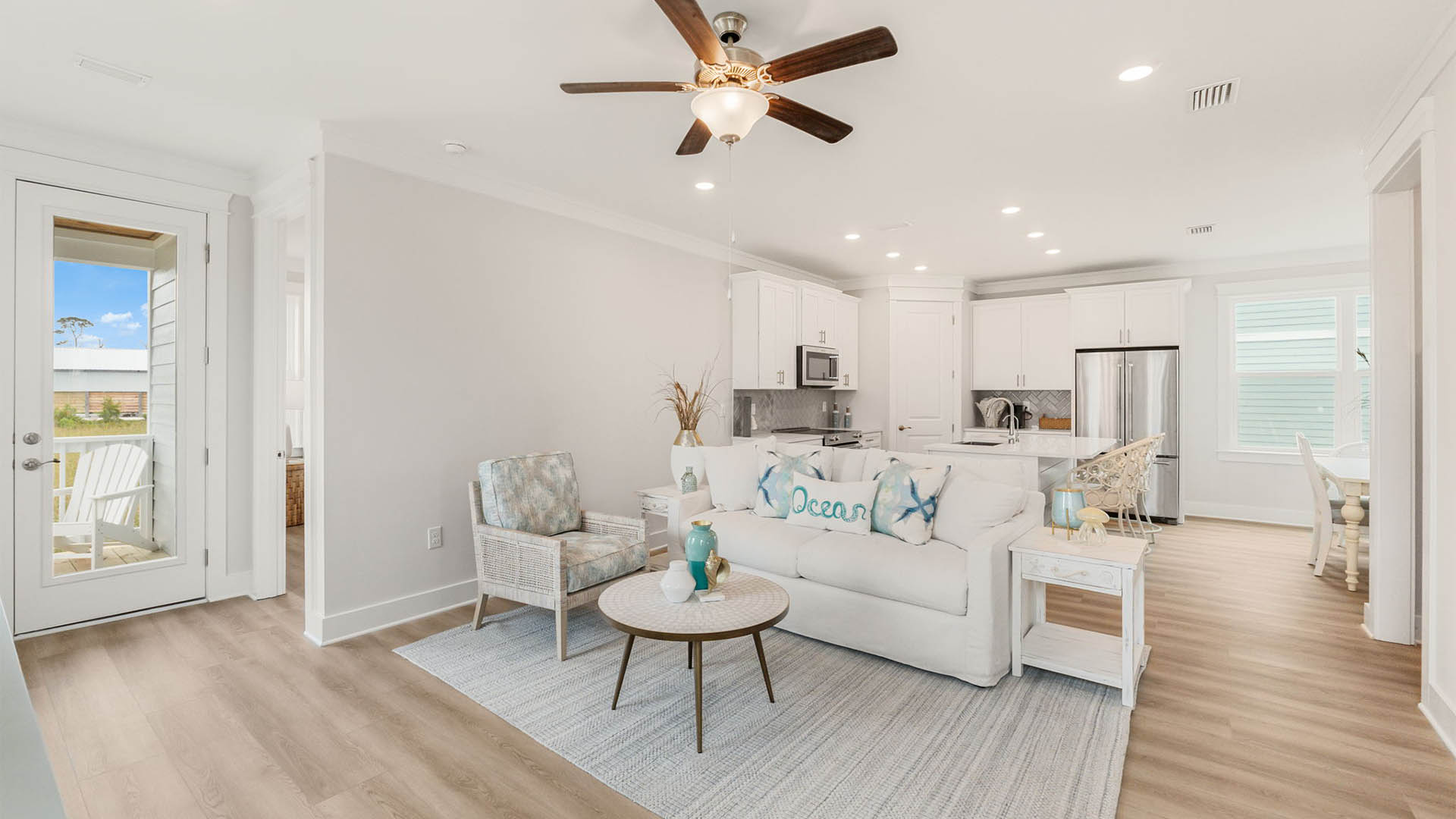 Furnished living room with EVP flooring and rear entrance to back porch.