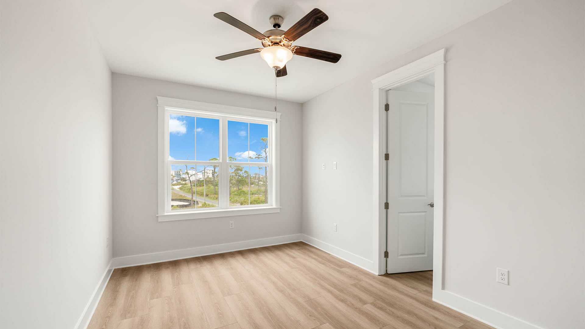 Bedroom with ceiling fan and EVP flooring.