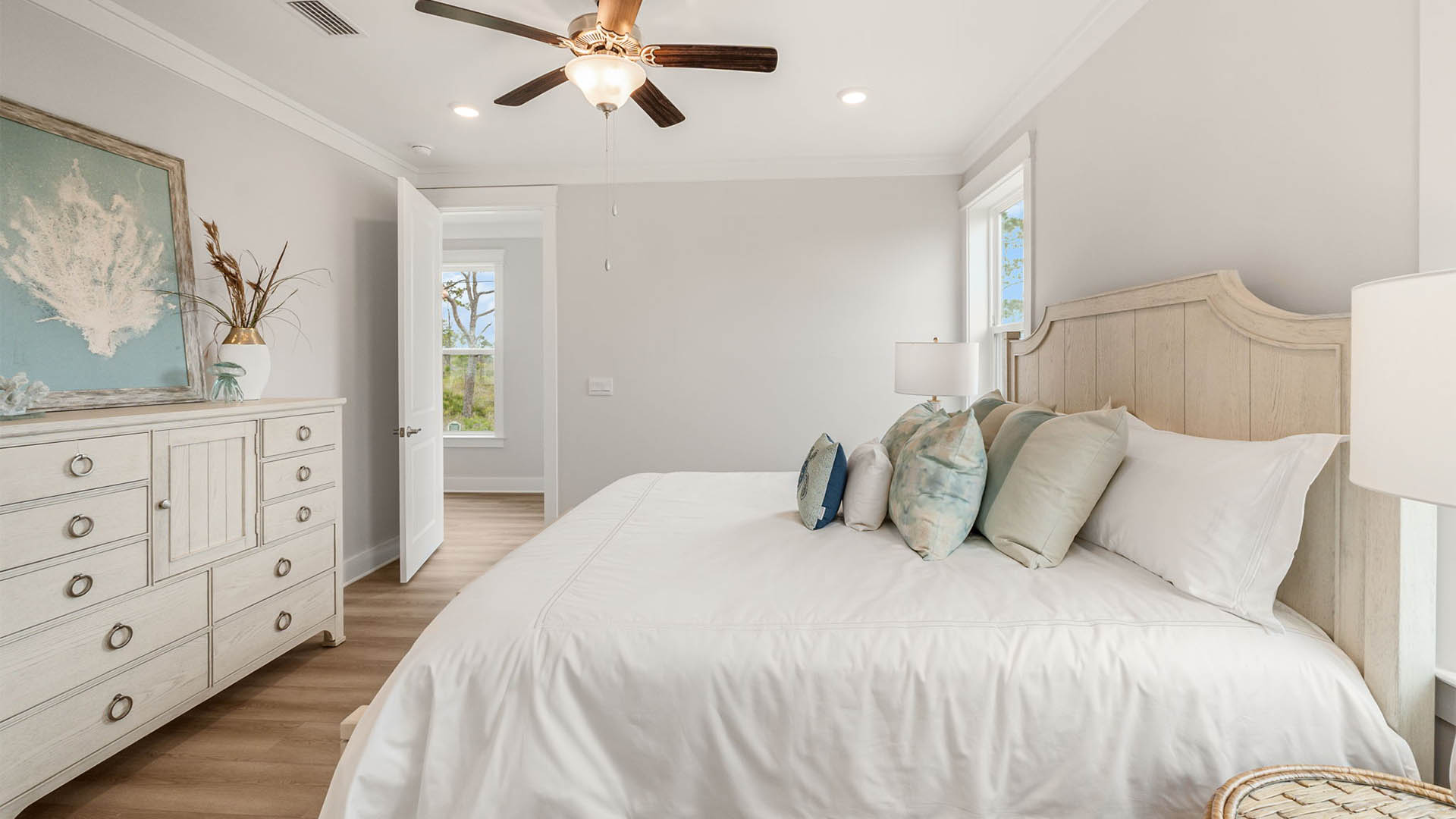 Furnished primary bedroom with EVP flooring.