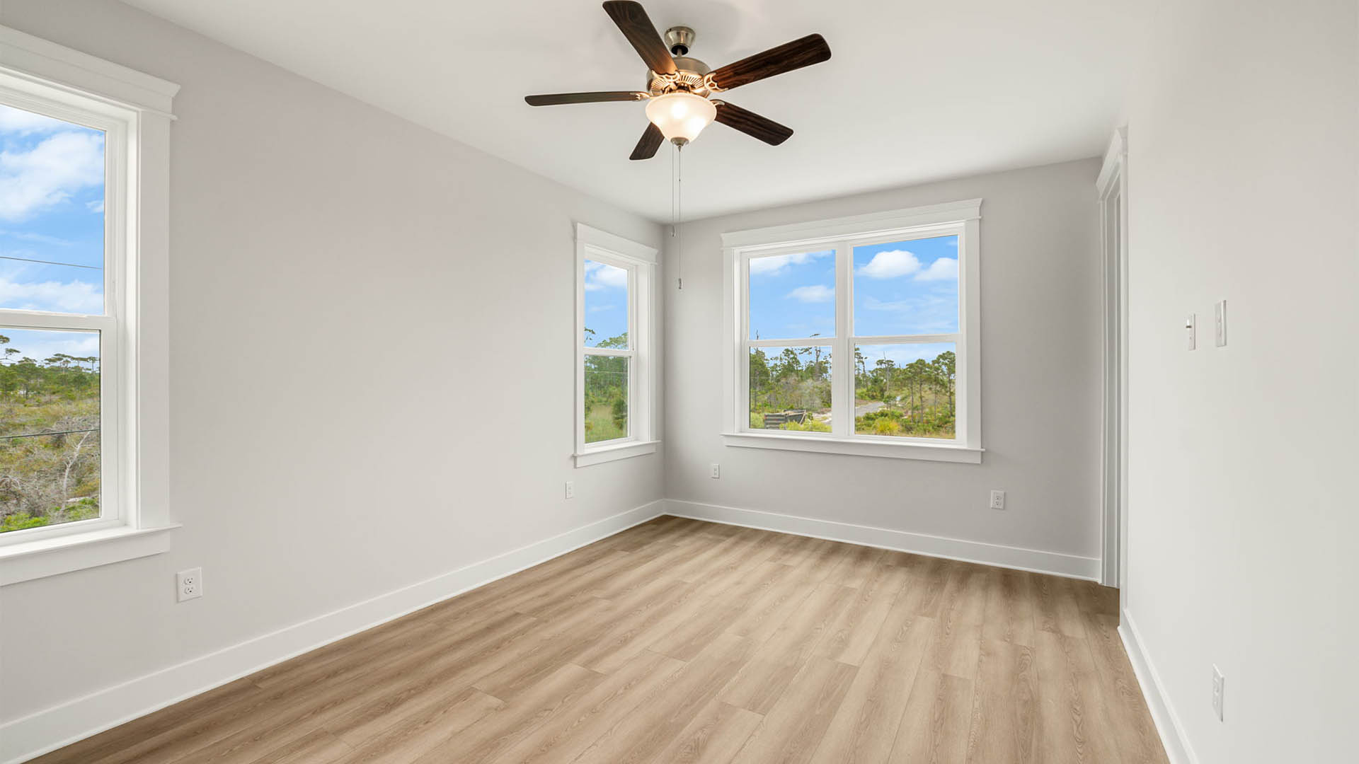 Bedroom with ceiling fan and EVP flooring.