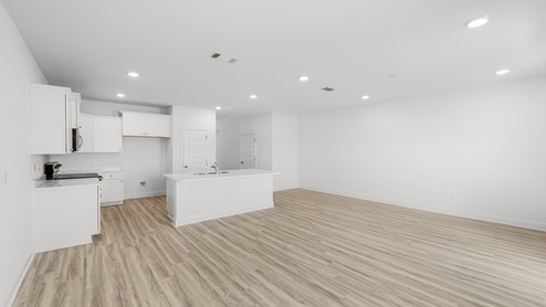 Open living room with kitchen island and dining area.