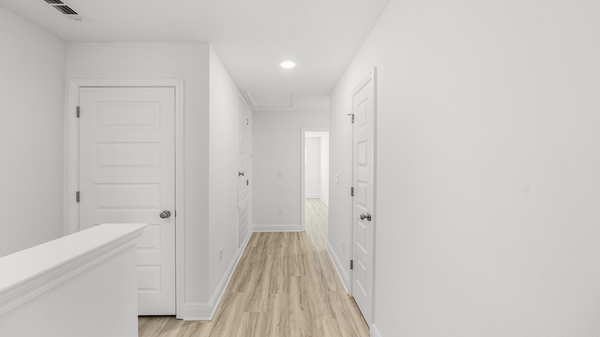 Top of staircase with bedroom entrance.