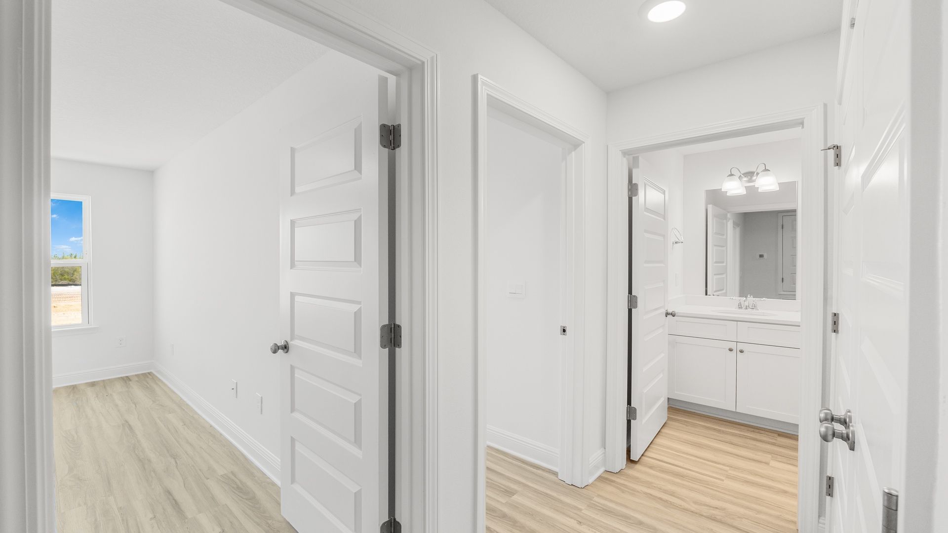 Hallway with bedroom and bathroom entrances.