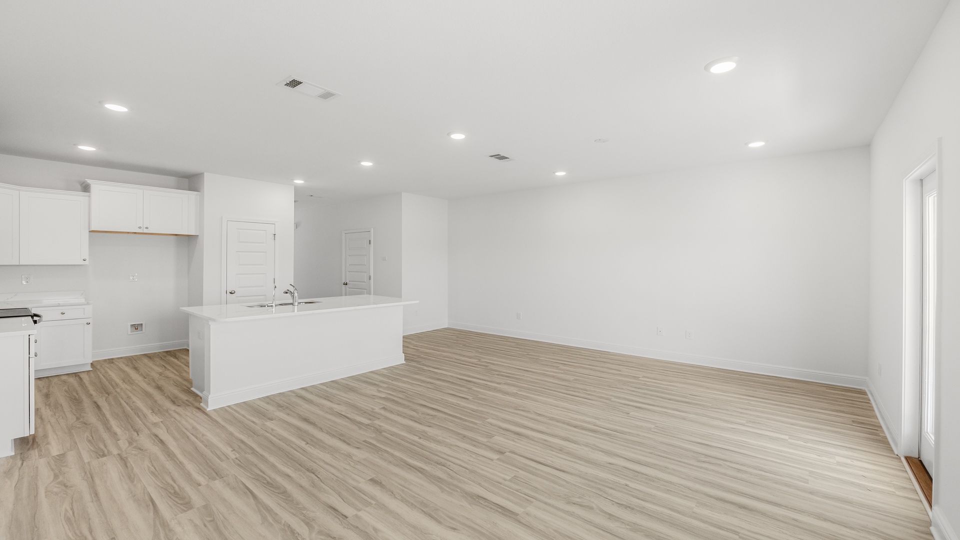 Open living room with kitchen island and dining area.