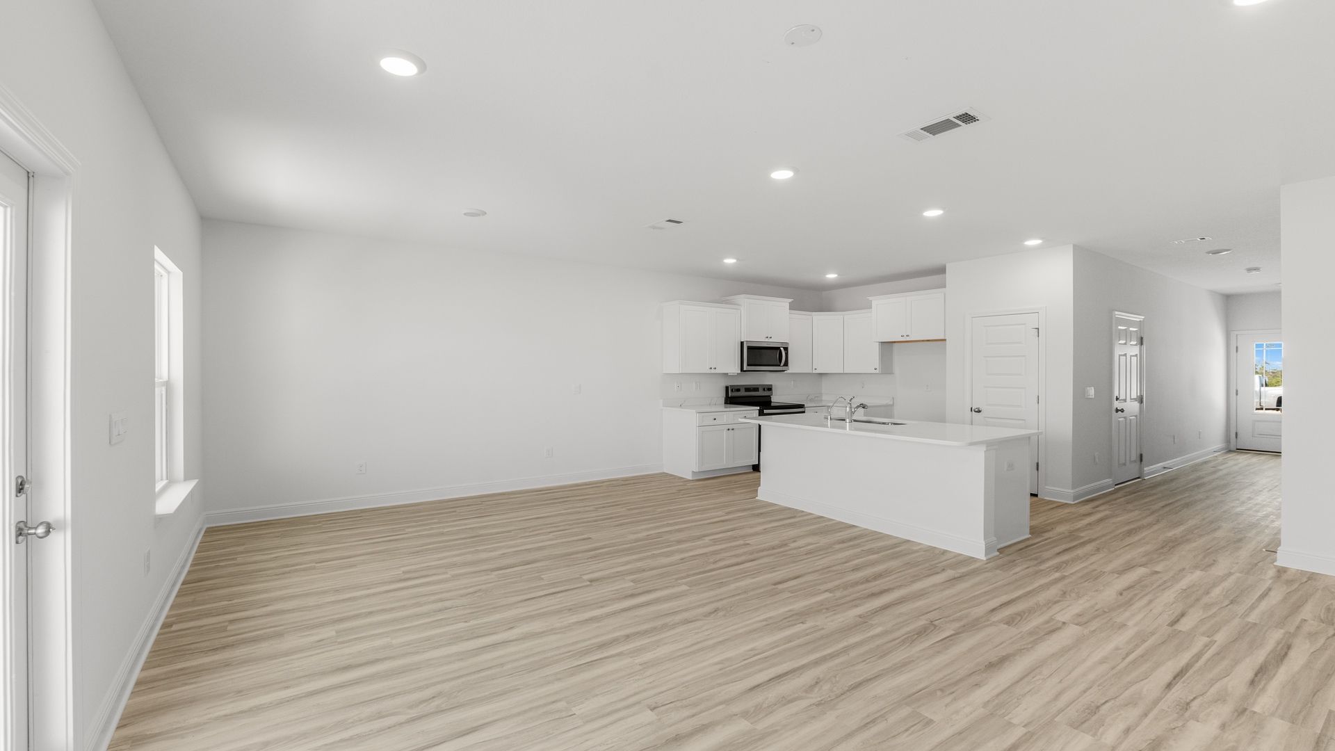 Open living room with kitchen island and dining area.