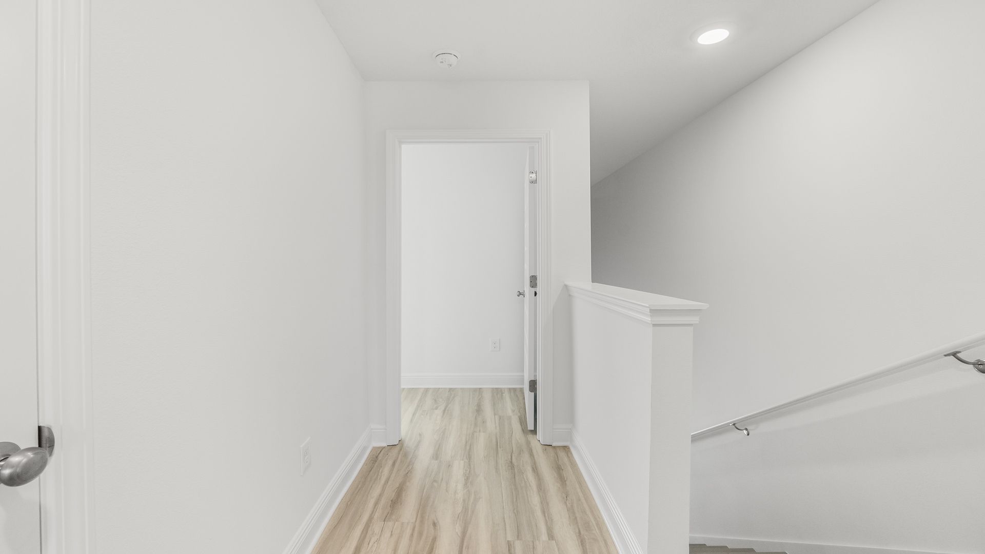 Top of staircase with bedroom entrance.