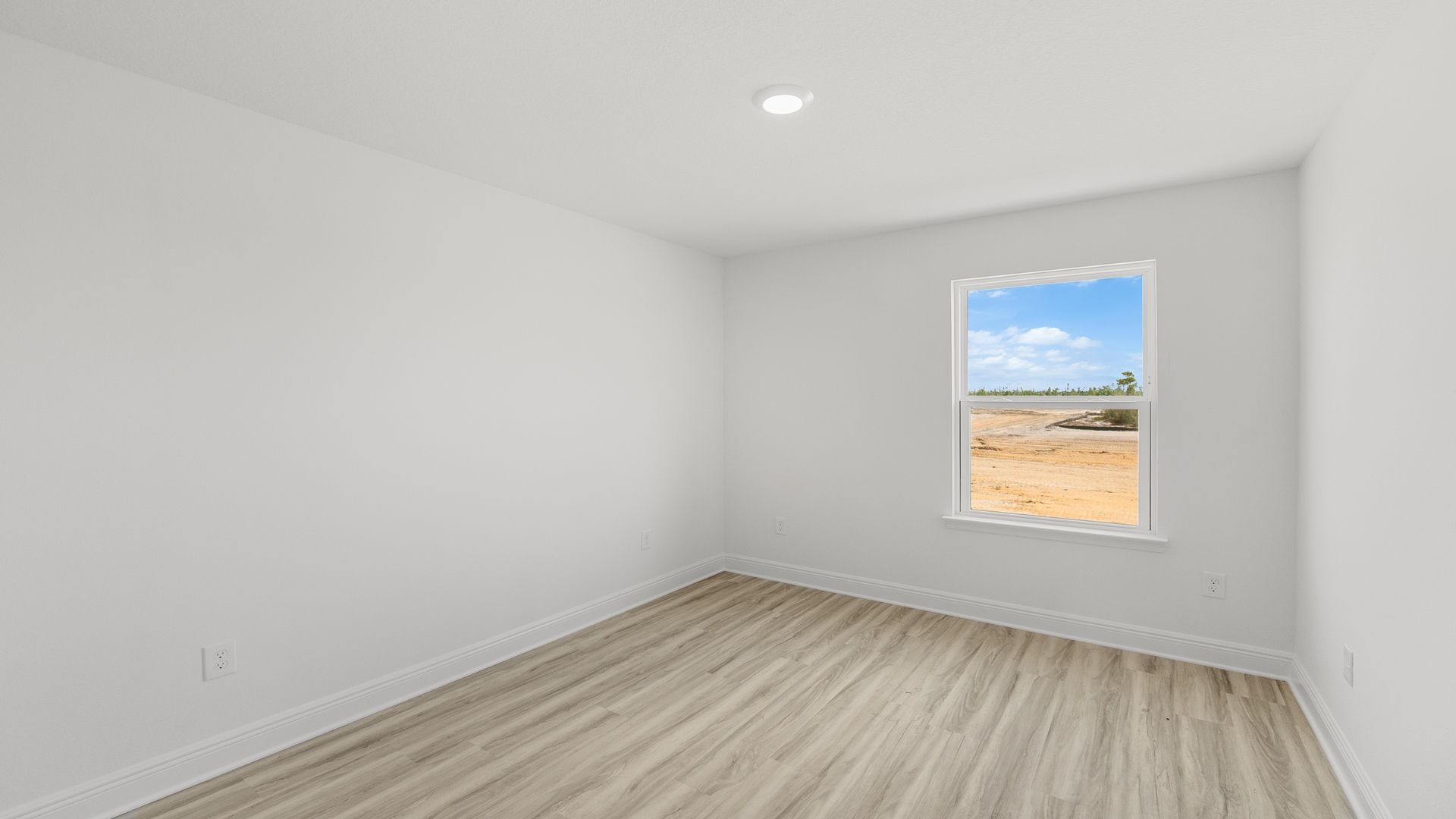Bedroom with EVP flooring and window.