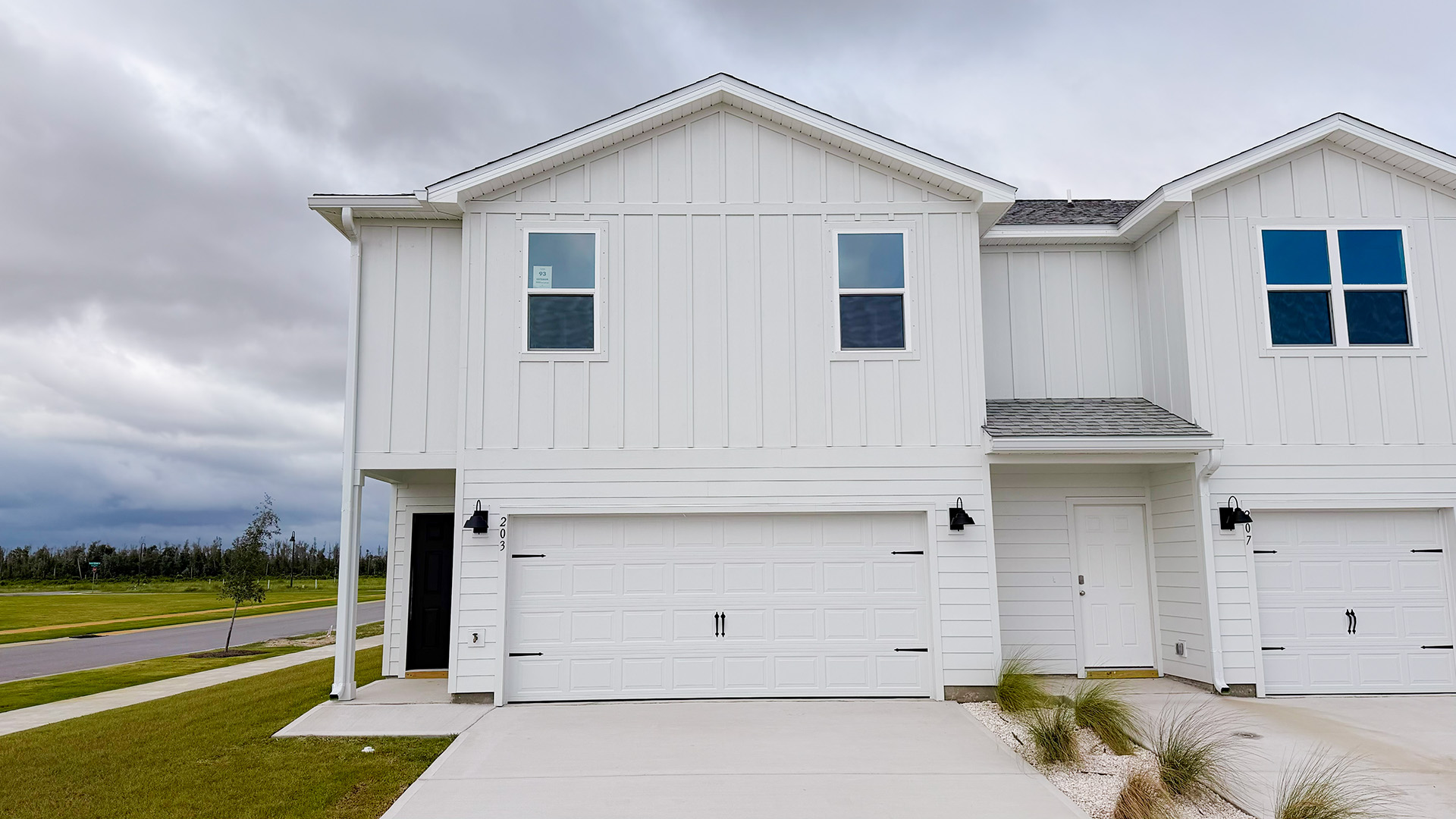 Two-Story Sabal townhome with 2-car garage and white Hardie Board siding.