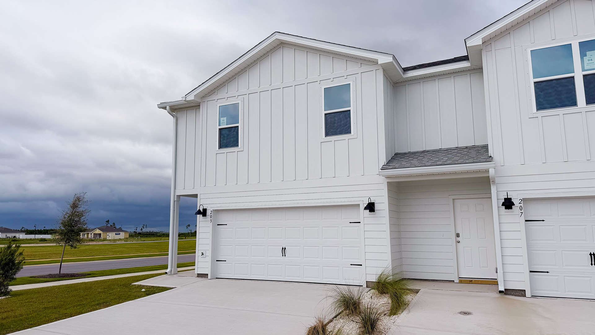 Two-Story Sabal townhome with 2-car garage and white Hardie Board siding.