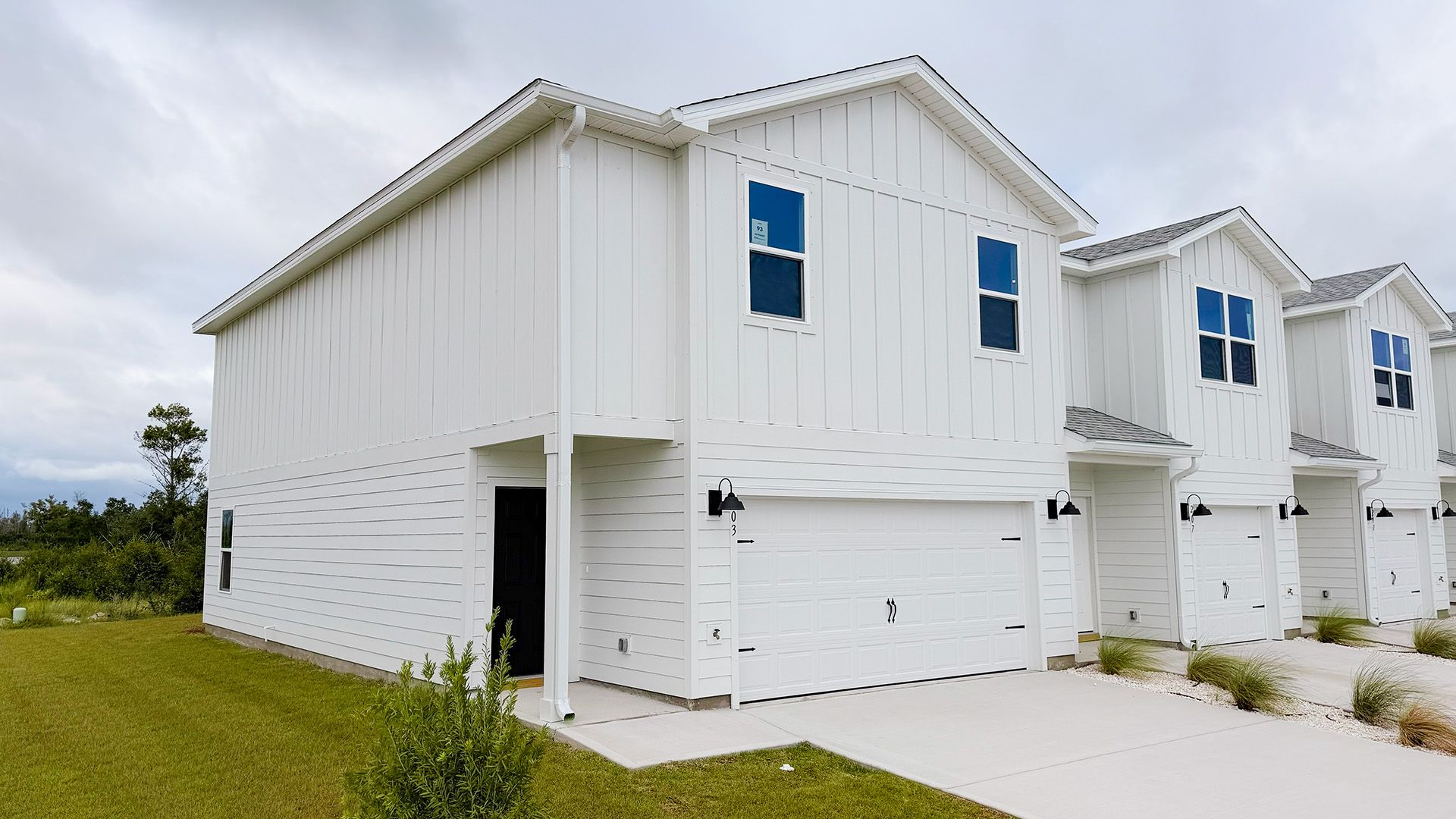Two-Story Sabal townhome with 2-car garage and white Hardie Board siding.