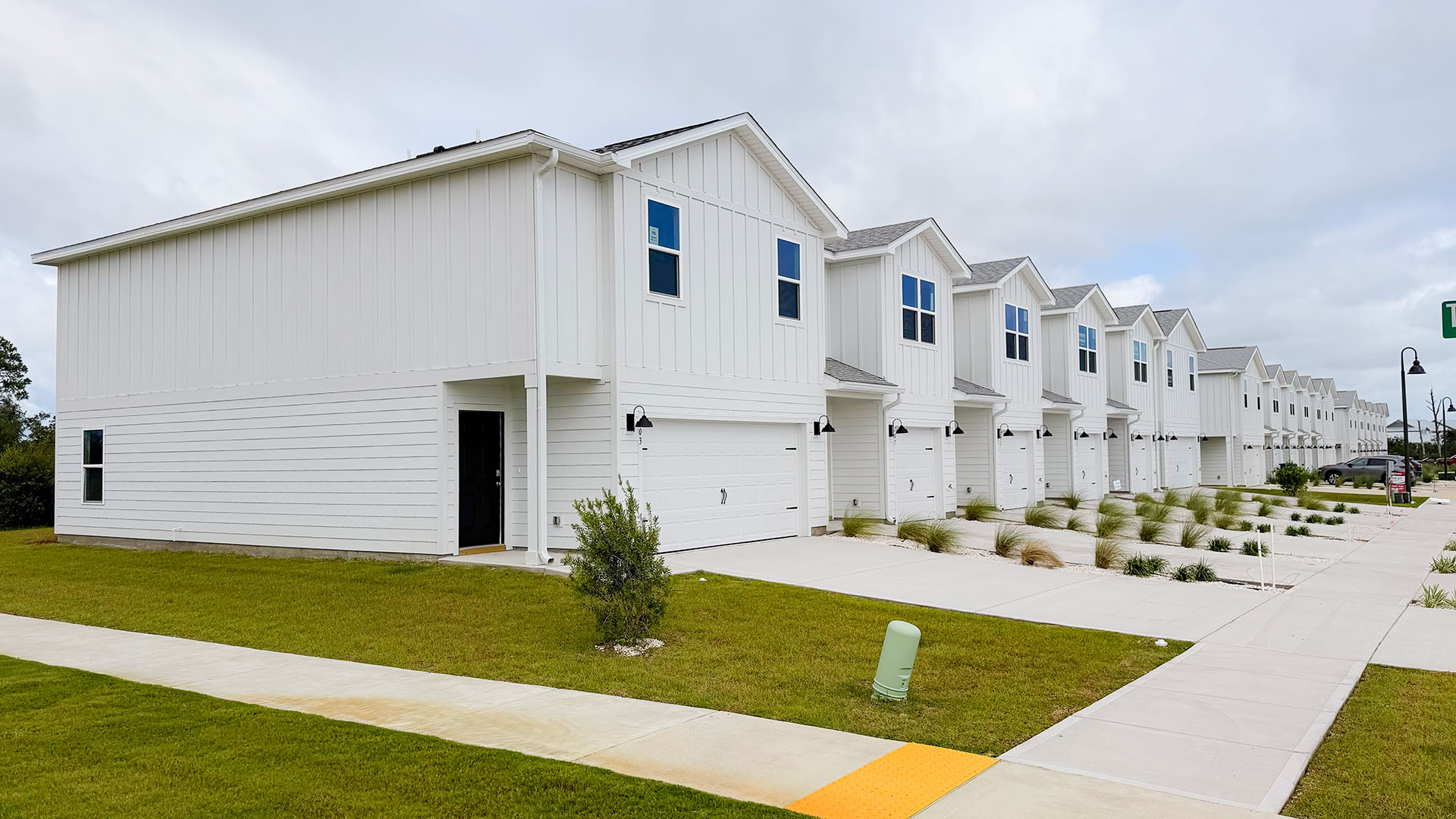 Two-Story Sabal townhome with 2-car garage and white Hardie Board siding.