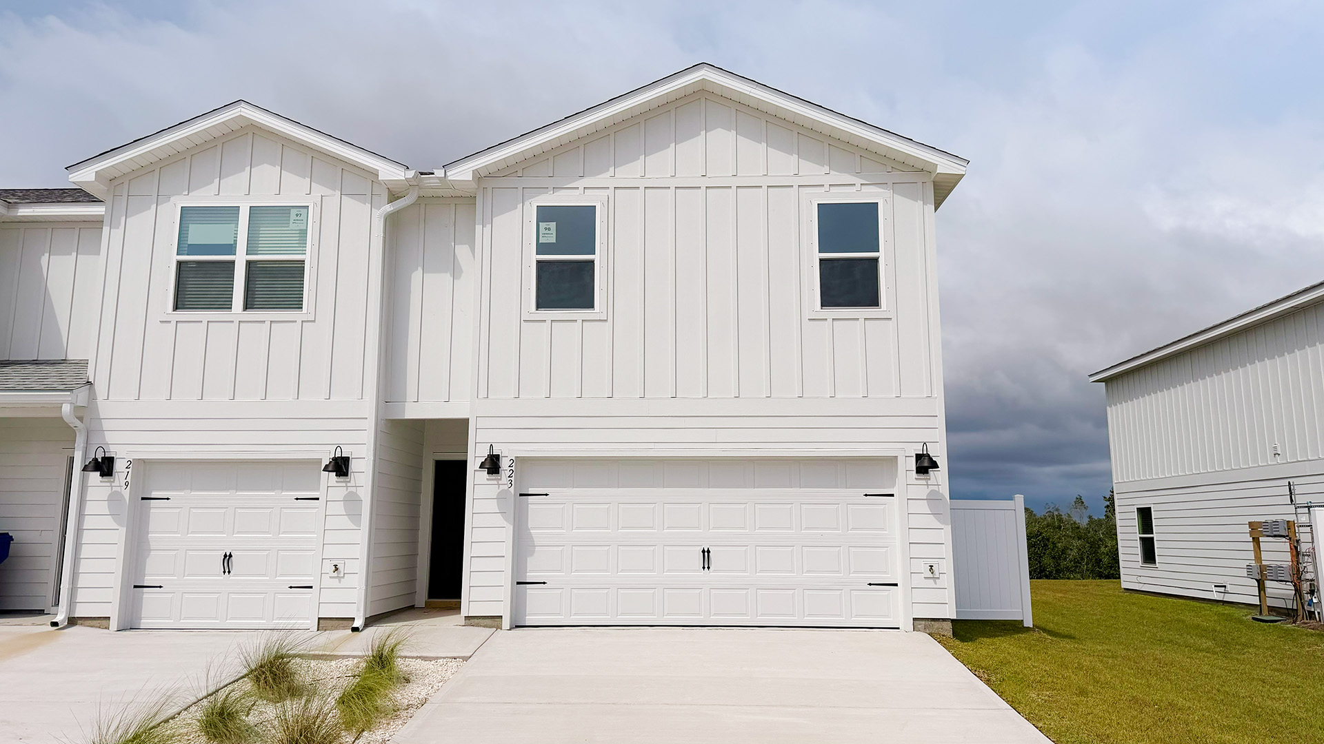 Two-Story Sabal townhome with 2-car garage and white Hardie Board siding.