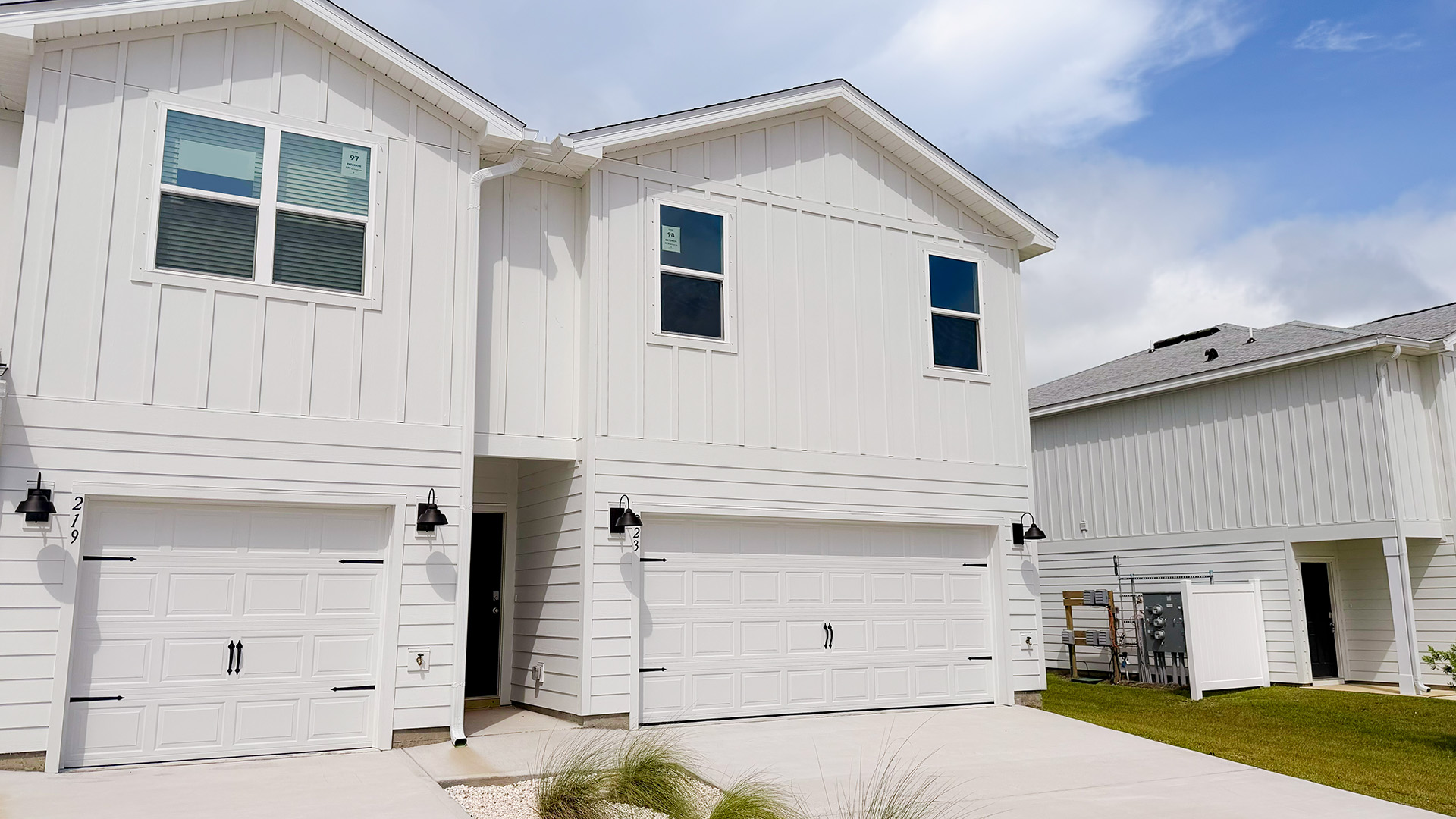 Two-Story Sabal townhome with 2-car garage and white Hardie Board siding.