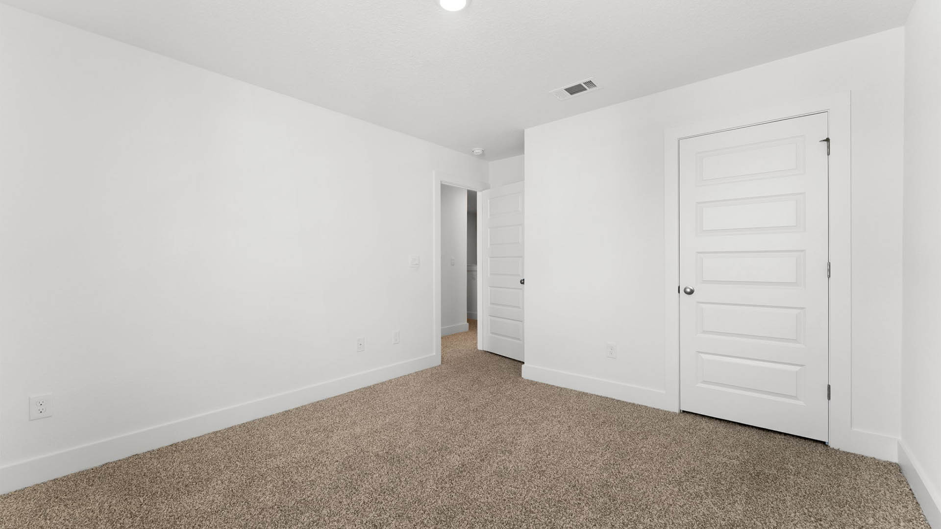 Bedroom with carpet flooring and closet.