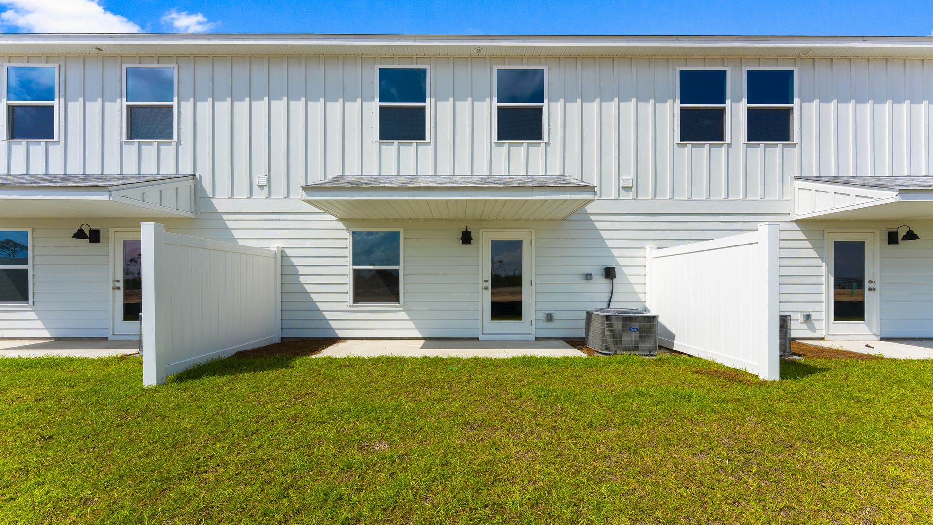 Covered back porch with air-conditioning unit.