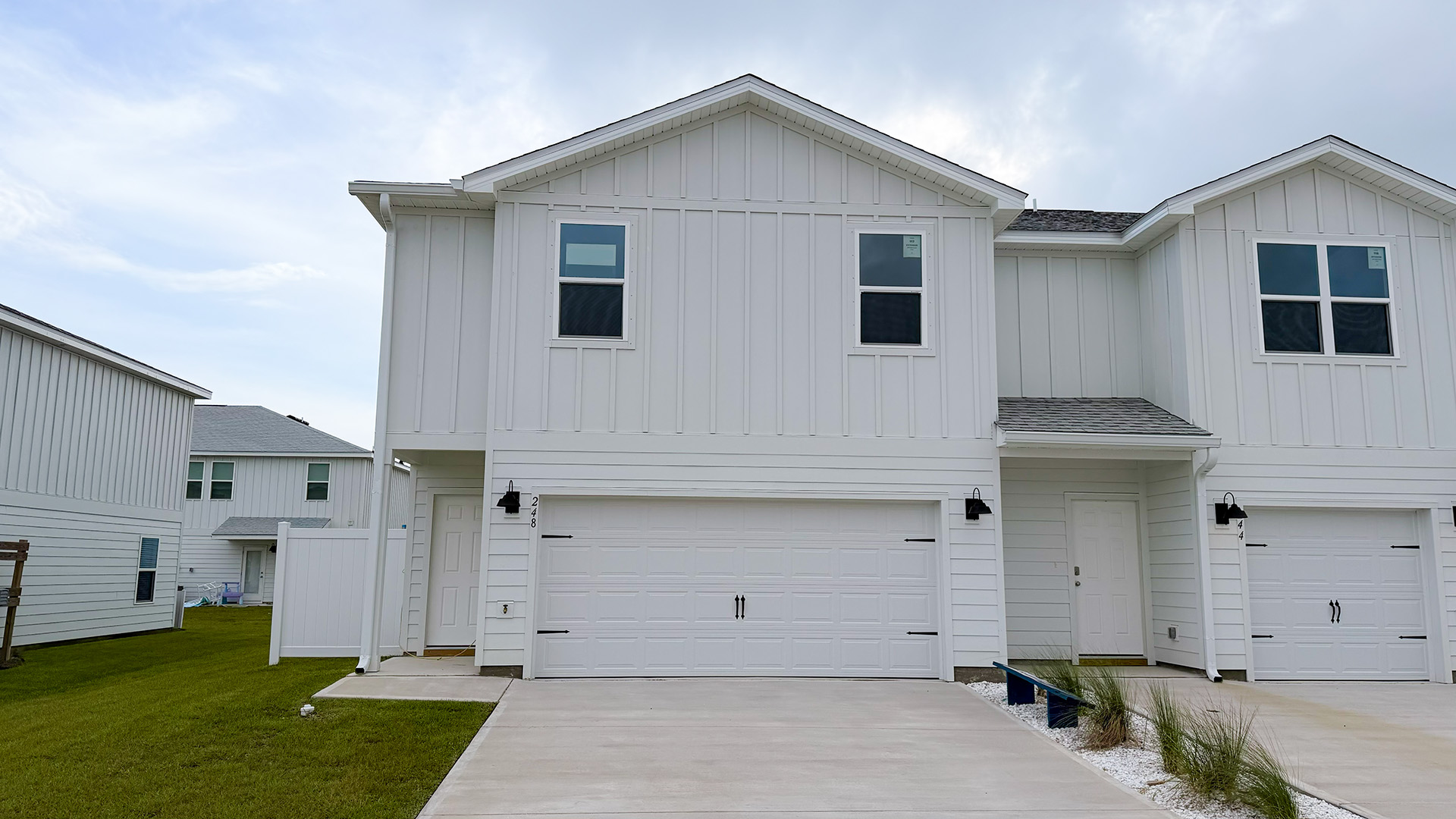 Two-Story Sabal townhome with 2-car garage and white Hardie Board siding.