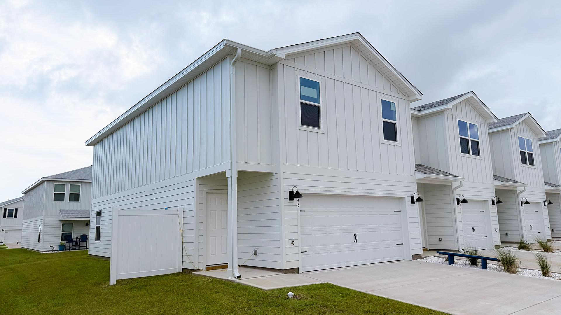 Two-Story Sabal townhome with 2-car garage and white Hardie Board siding.
