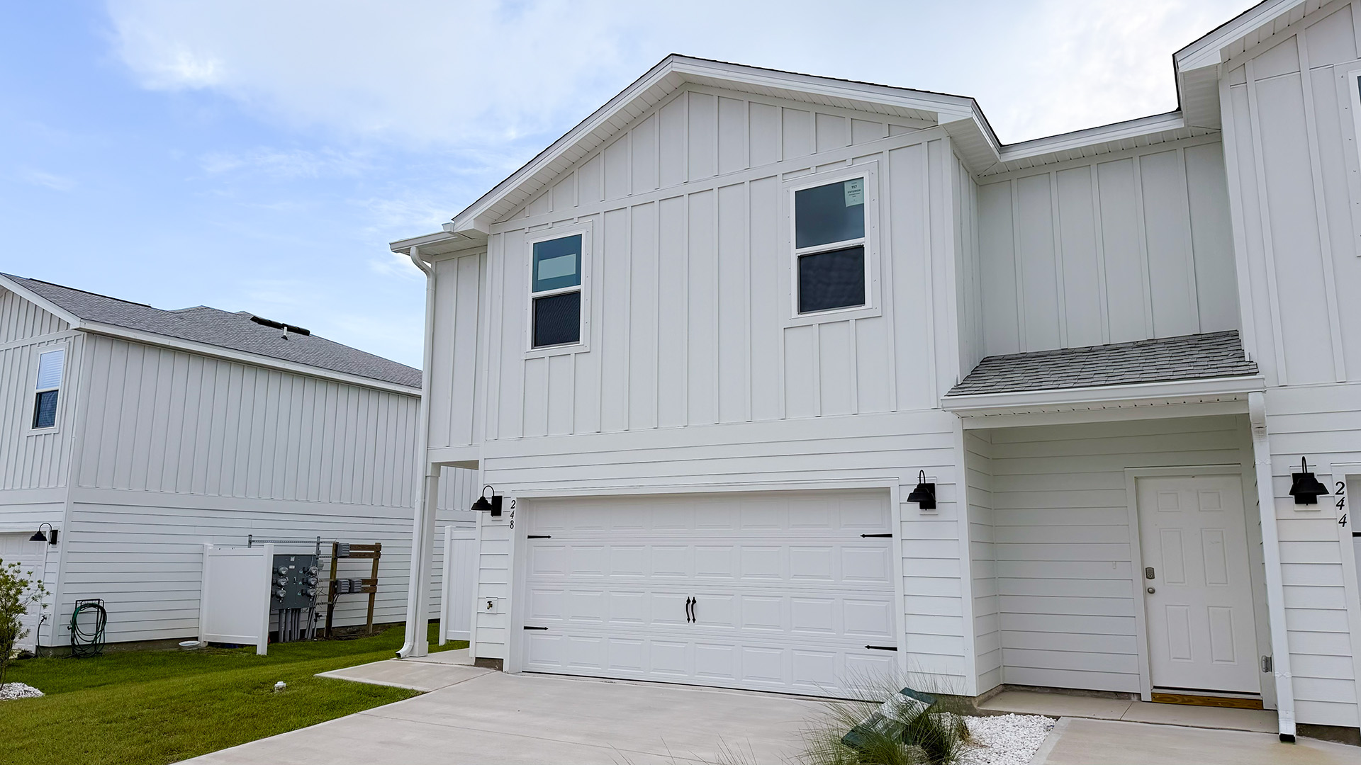 Two-Story Sabal townhome with 2-car garage and white Hardie Board siding.