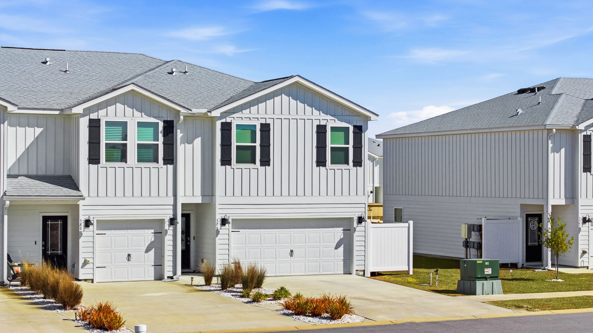 Two-Story Sabal townhome with 2-car garage and white Hardie Board siding.