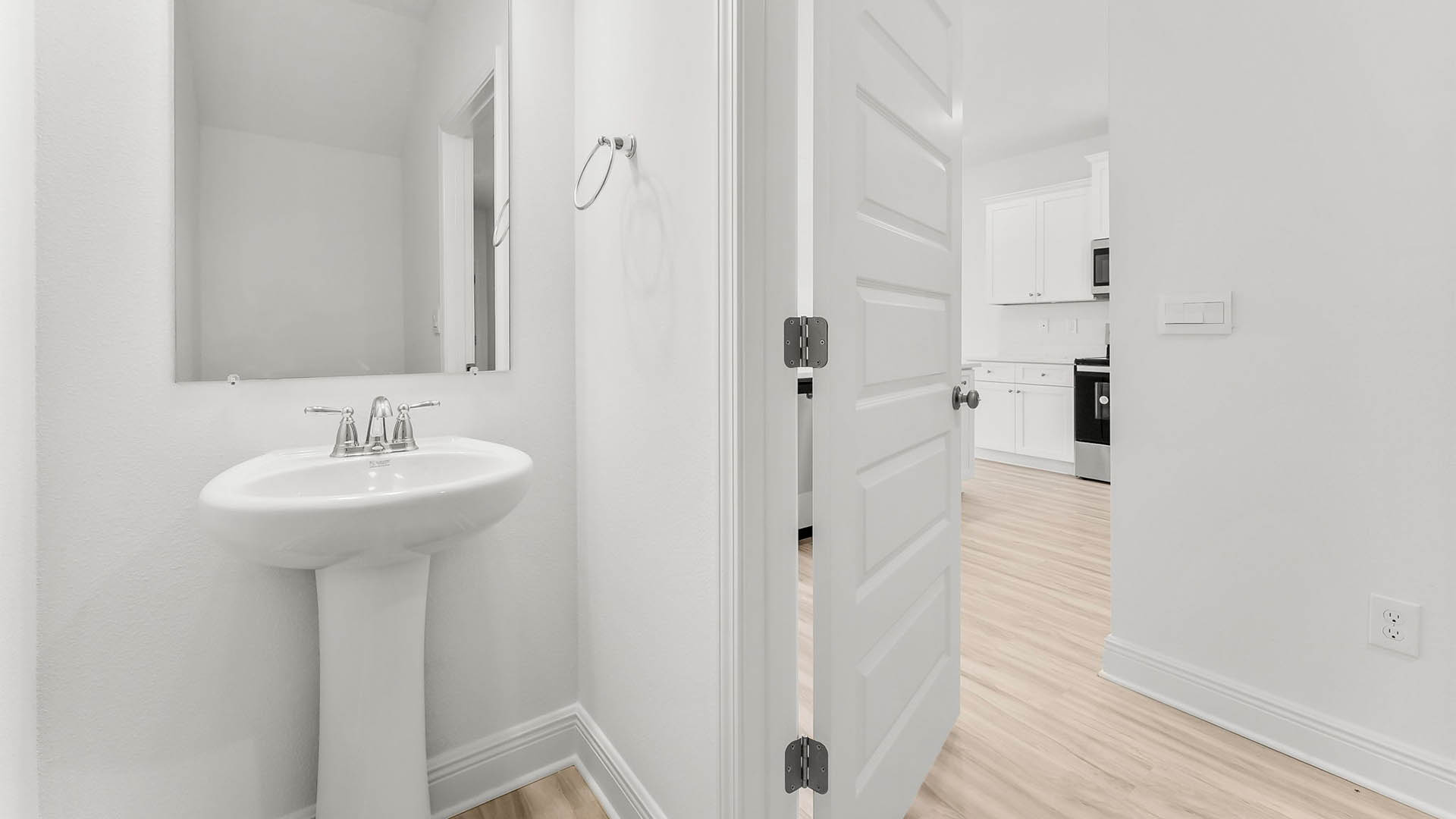 Half bathroom with sink and mirror.