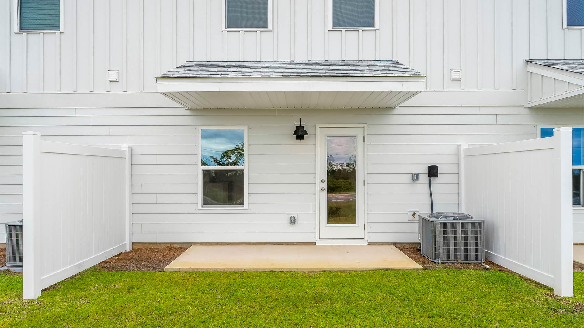 Backyard with partition and covered patio.