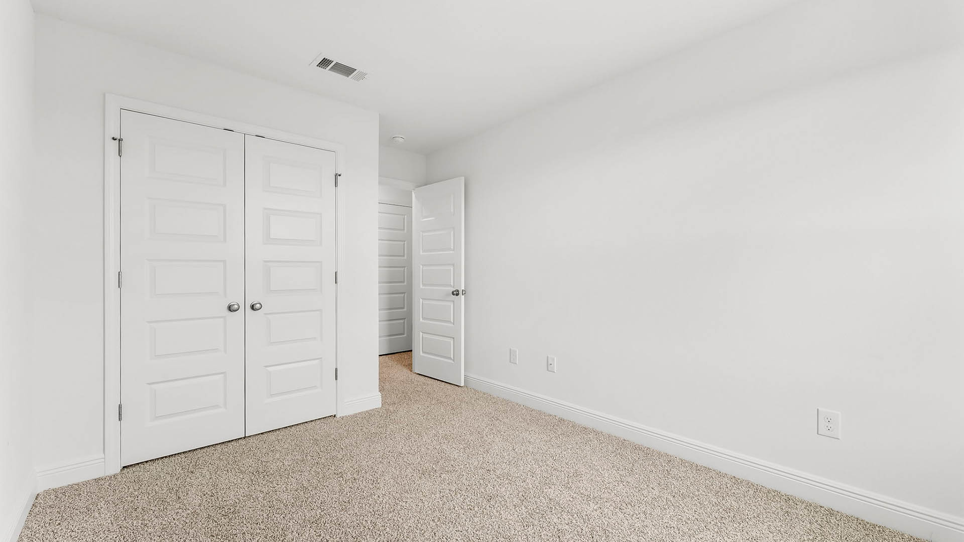 Bedroom with carpet floors and closet.