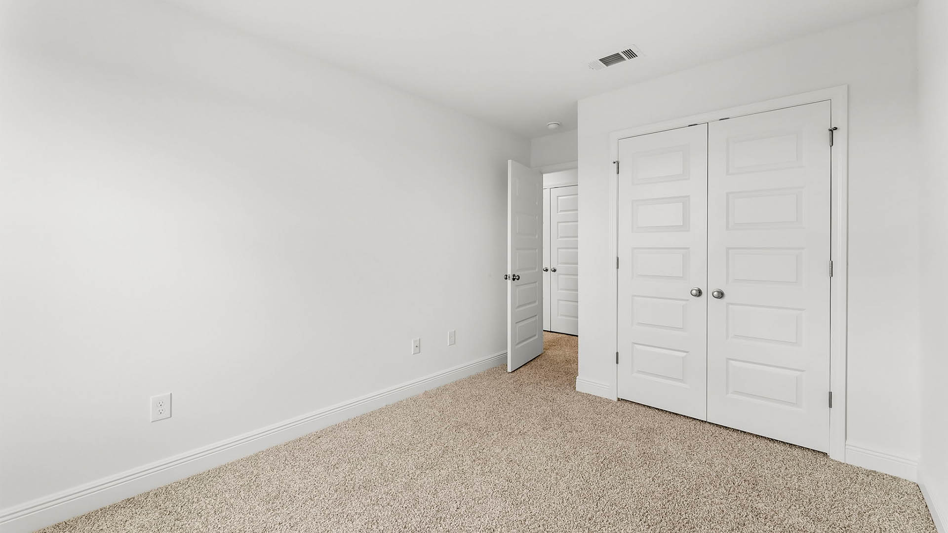Bedroom with carpet floors and closet.