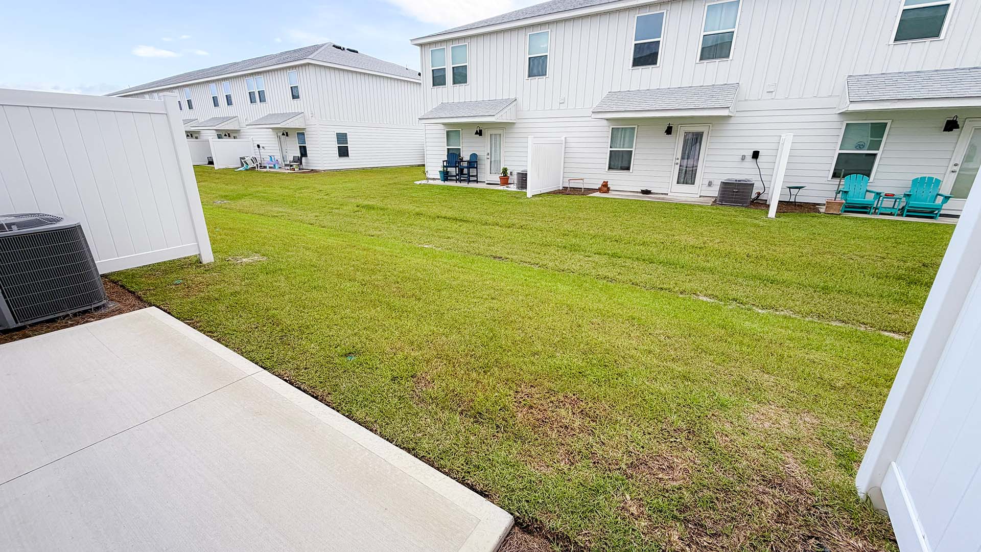 Backyard with partition and covered patio.