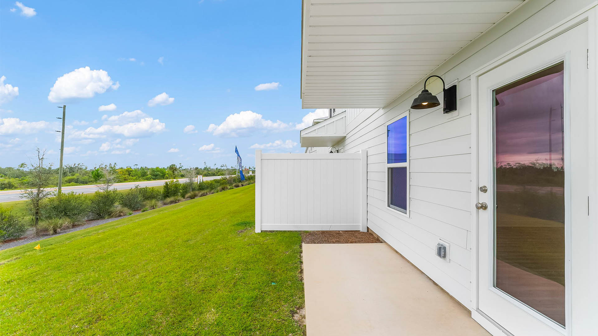 Backyard view with partition and covered patio.