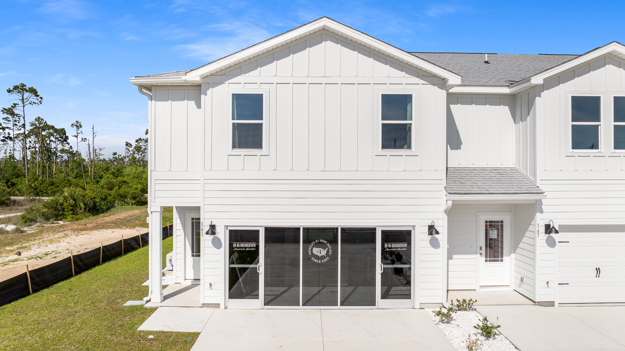 Sabal Townhome exterior unit at WindMark Beach with Hardie Board siding and two car garage.
