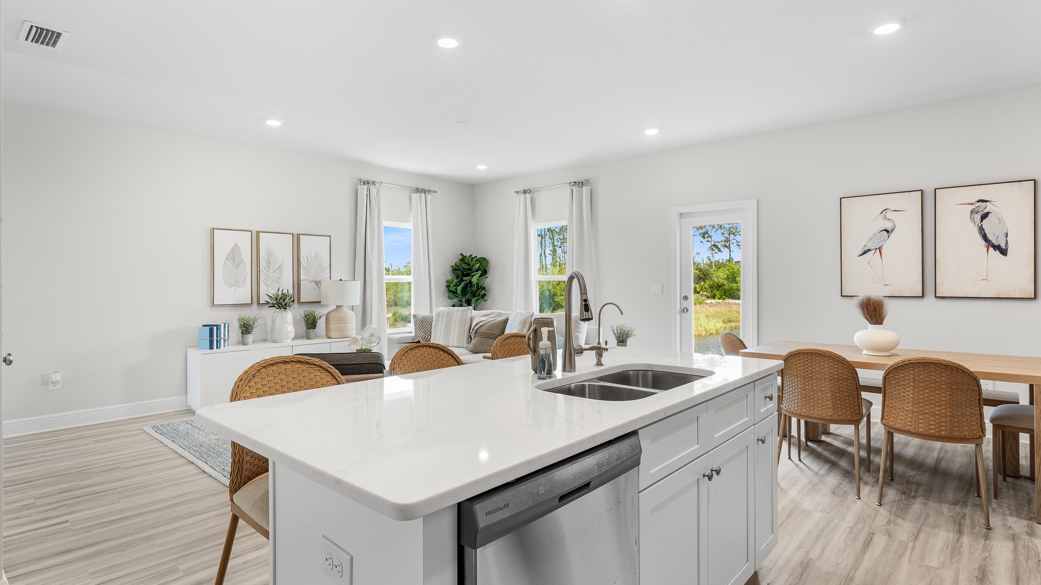 Kitchen island with quartz countertops and living room and dining room.