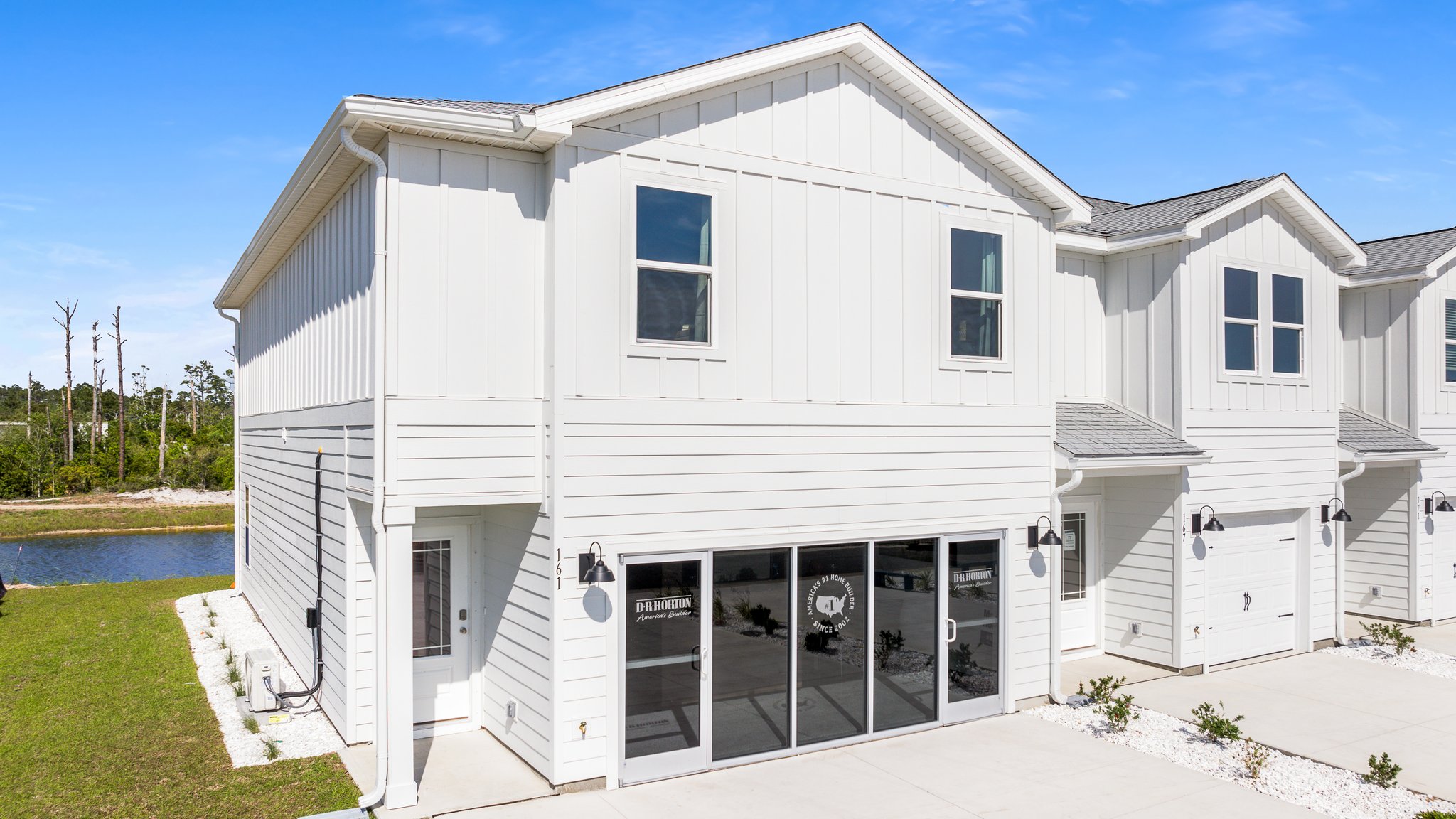 Sabal Townhome exterior unit at WindMark Beach with Hardie Board siding and two car garage.