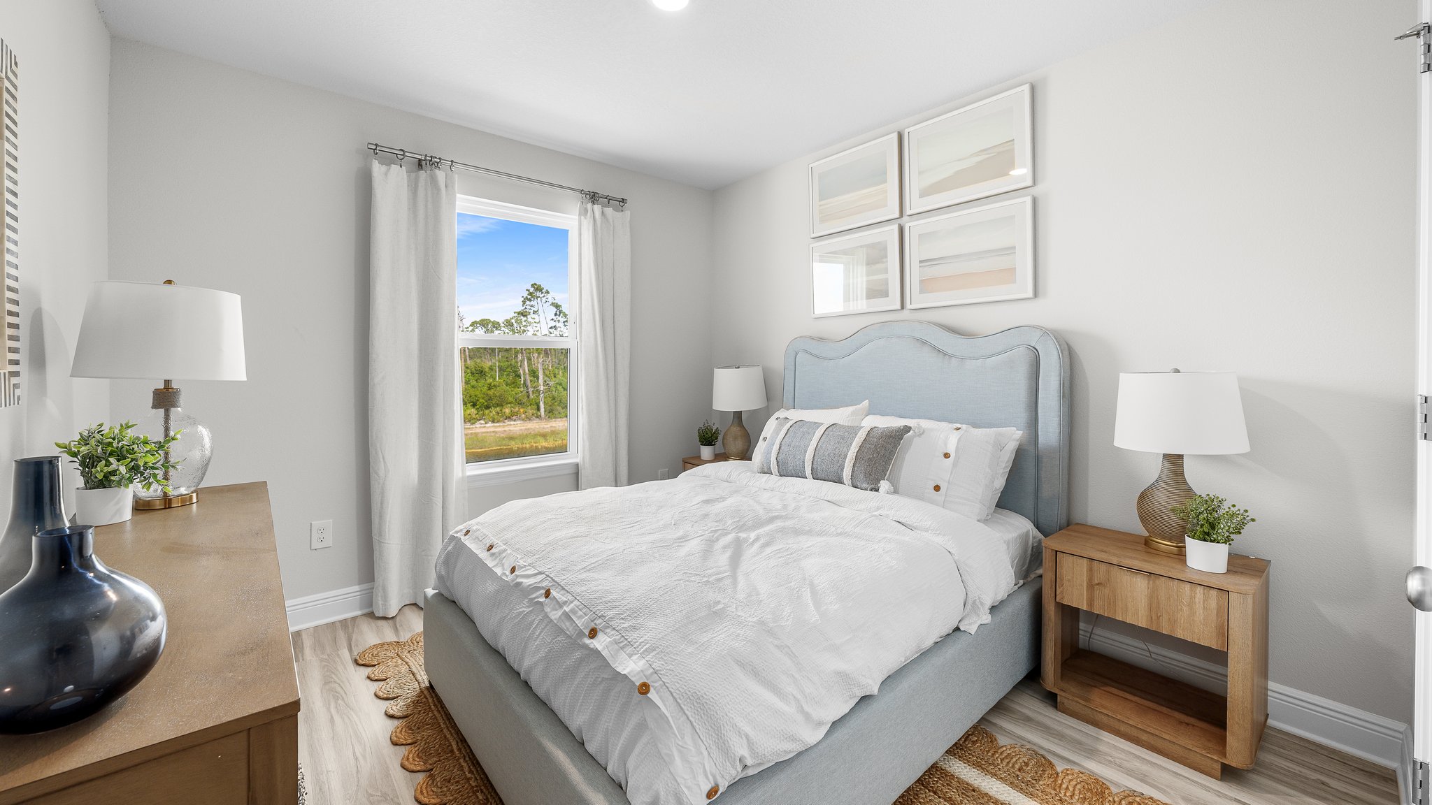 Bedroom with EVP flooring and windows.