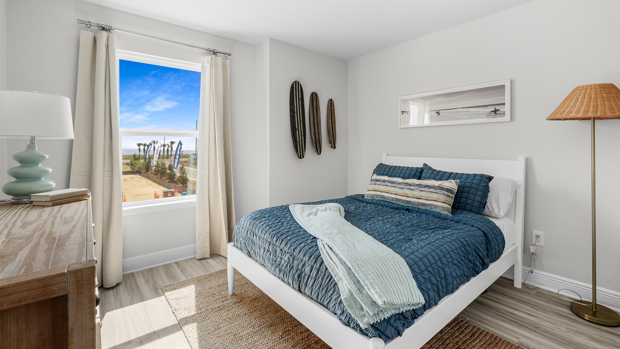 Bedroom with EVP flooring and windows.