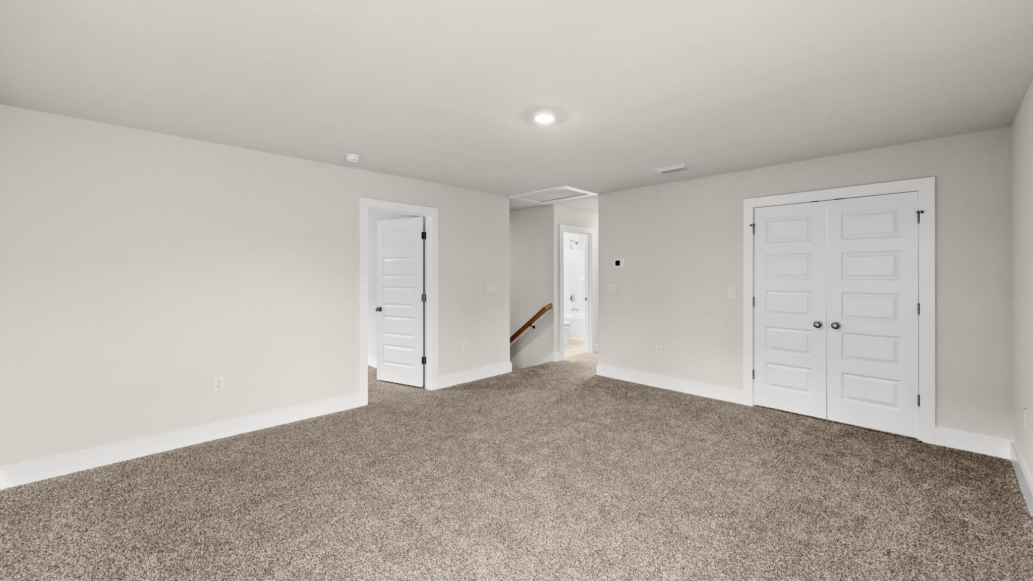 Upstairs common area with window and bedroom entrances.
