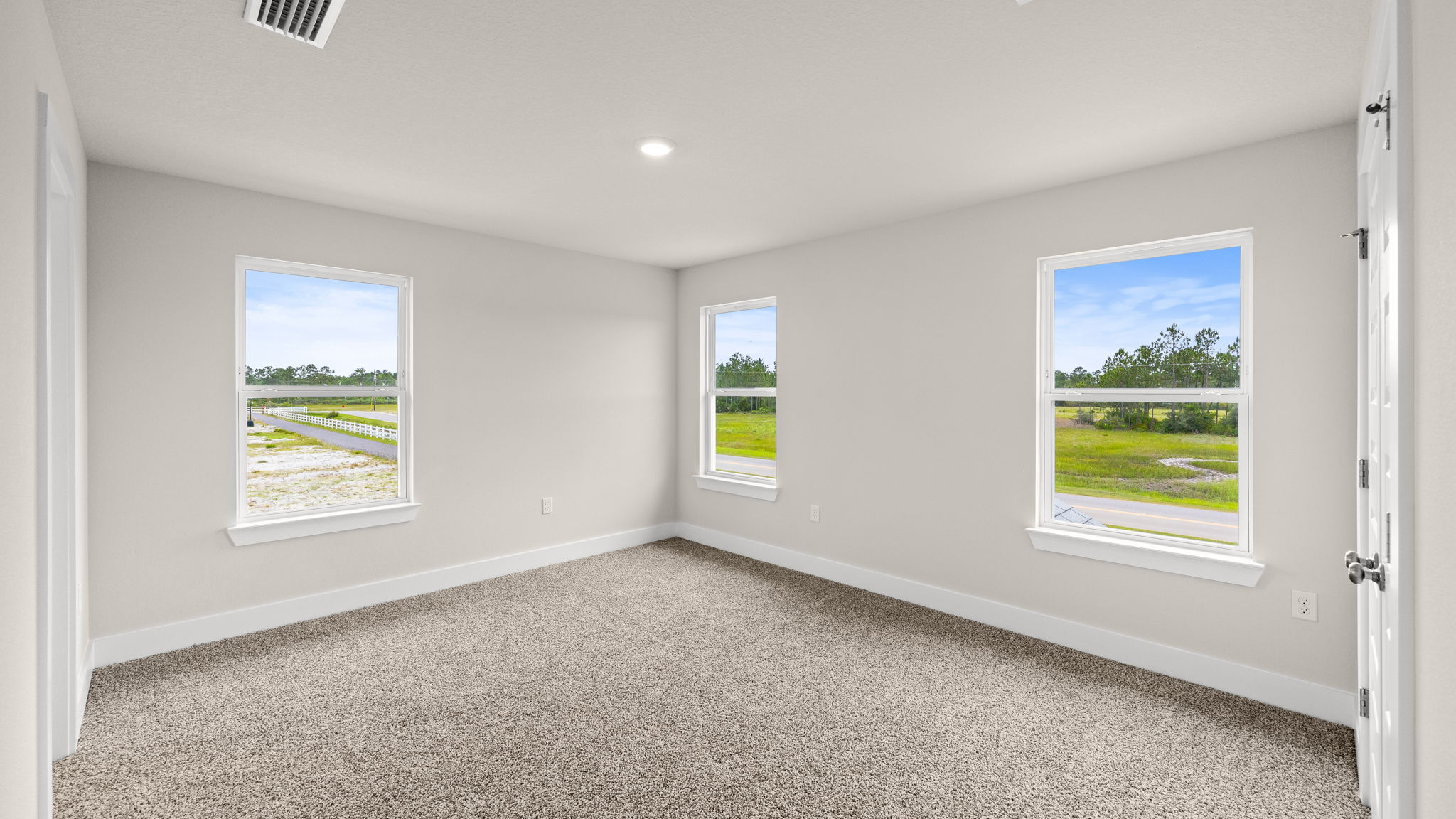 Bedroom with carpet flooring and window.