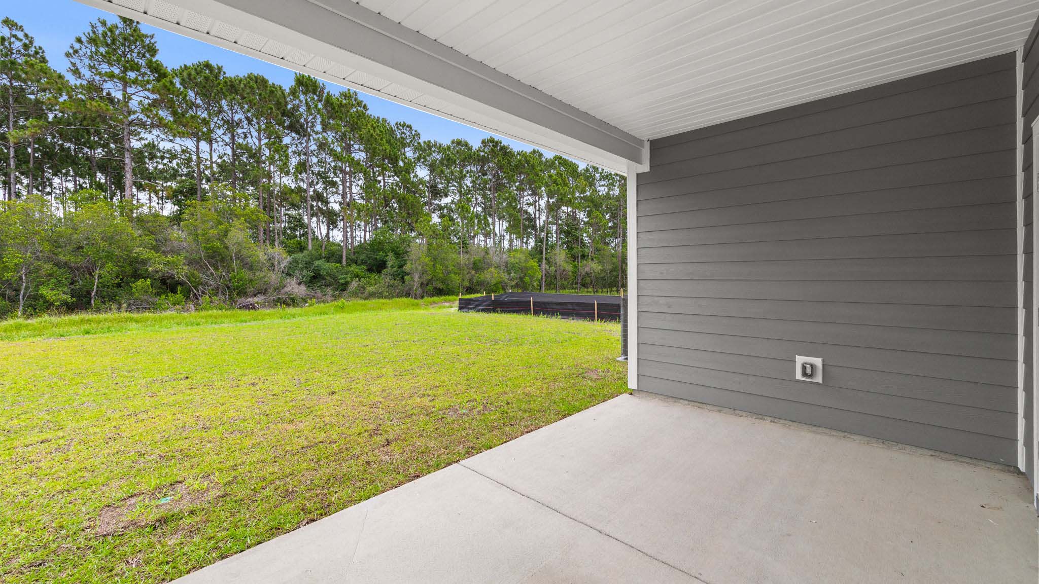 Covered rear patio of Alabaster floor plan at Buffer Farms.