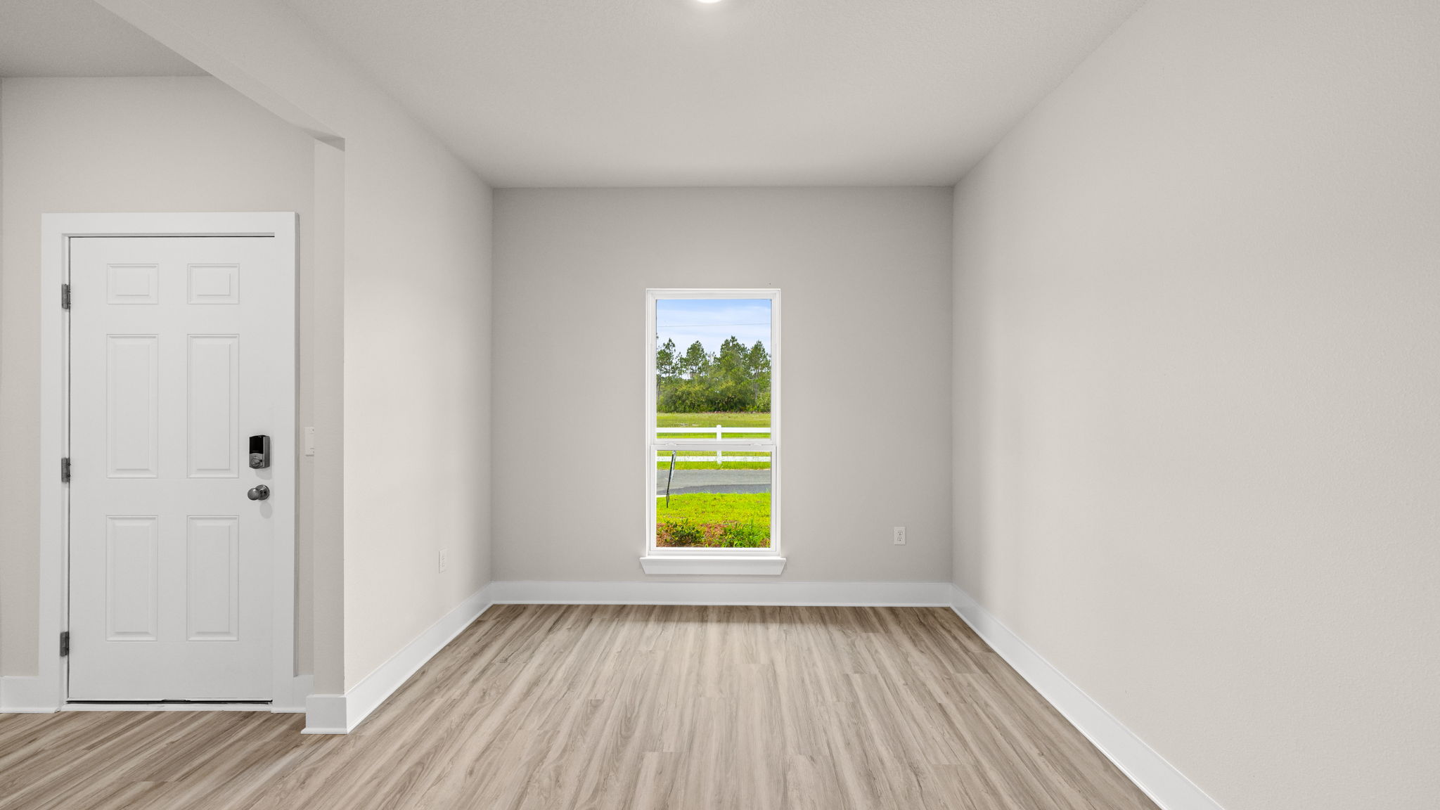Dining room with EVP flooring and window.