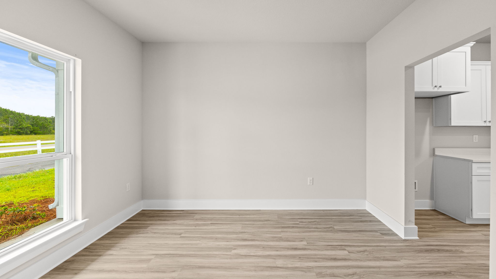 Dining room with EVP flooring and window.