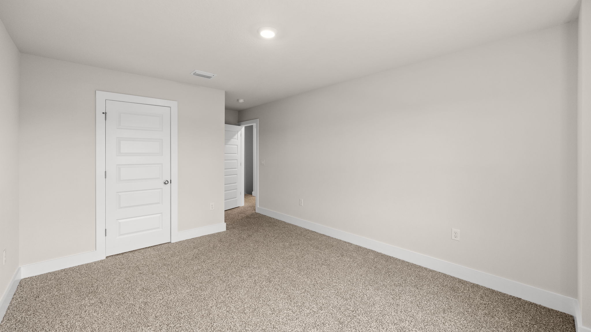 Bedroom with carpet flooring and closet.