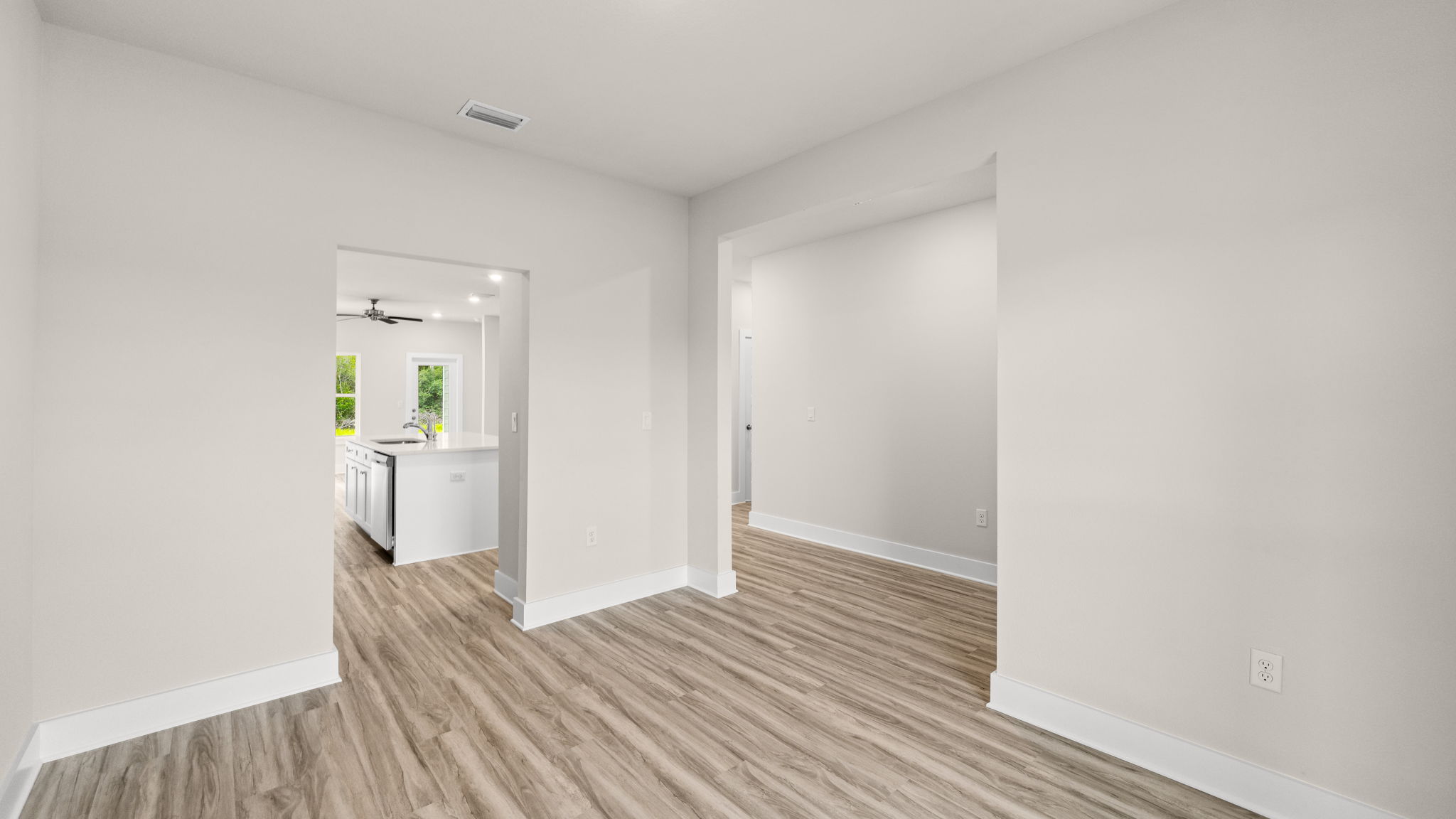Dining room and kitchen entryway and front door entrance.